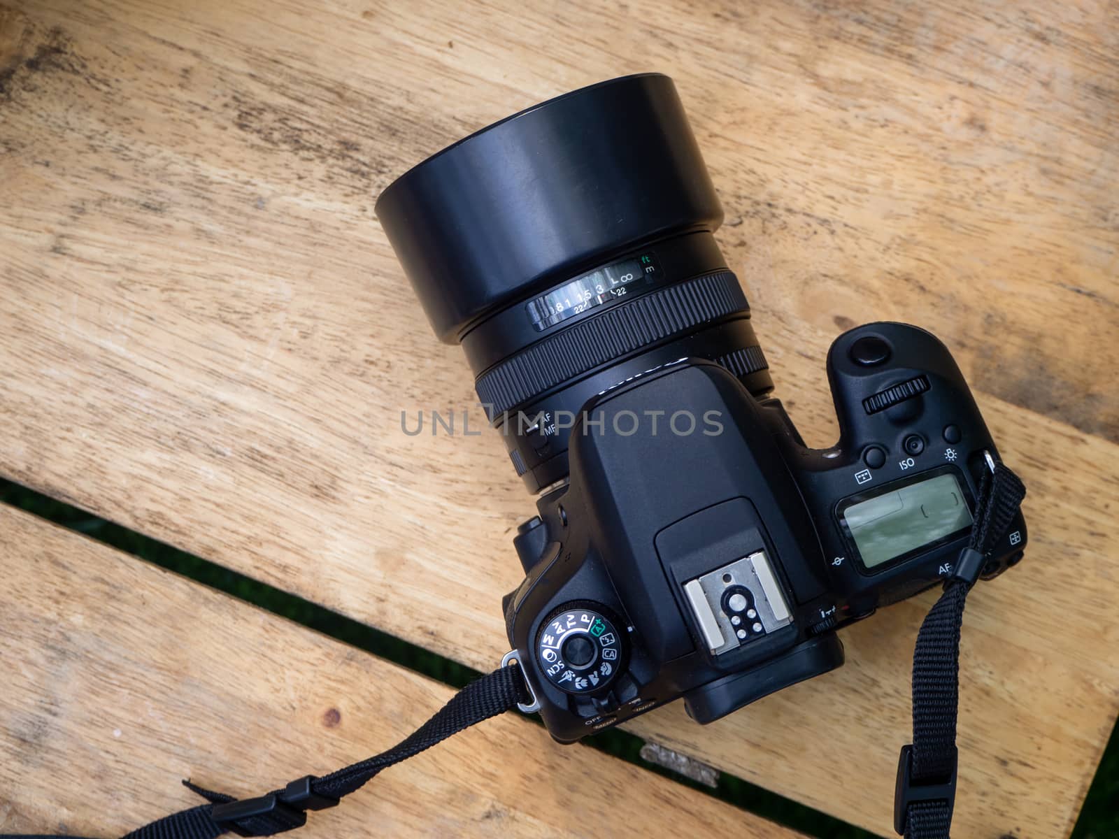 Wood photographter office desk table with digital camera and lens and computer tools
