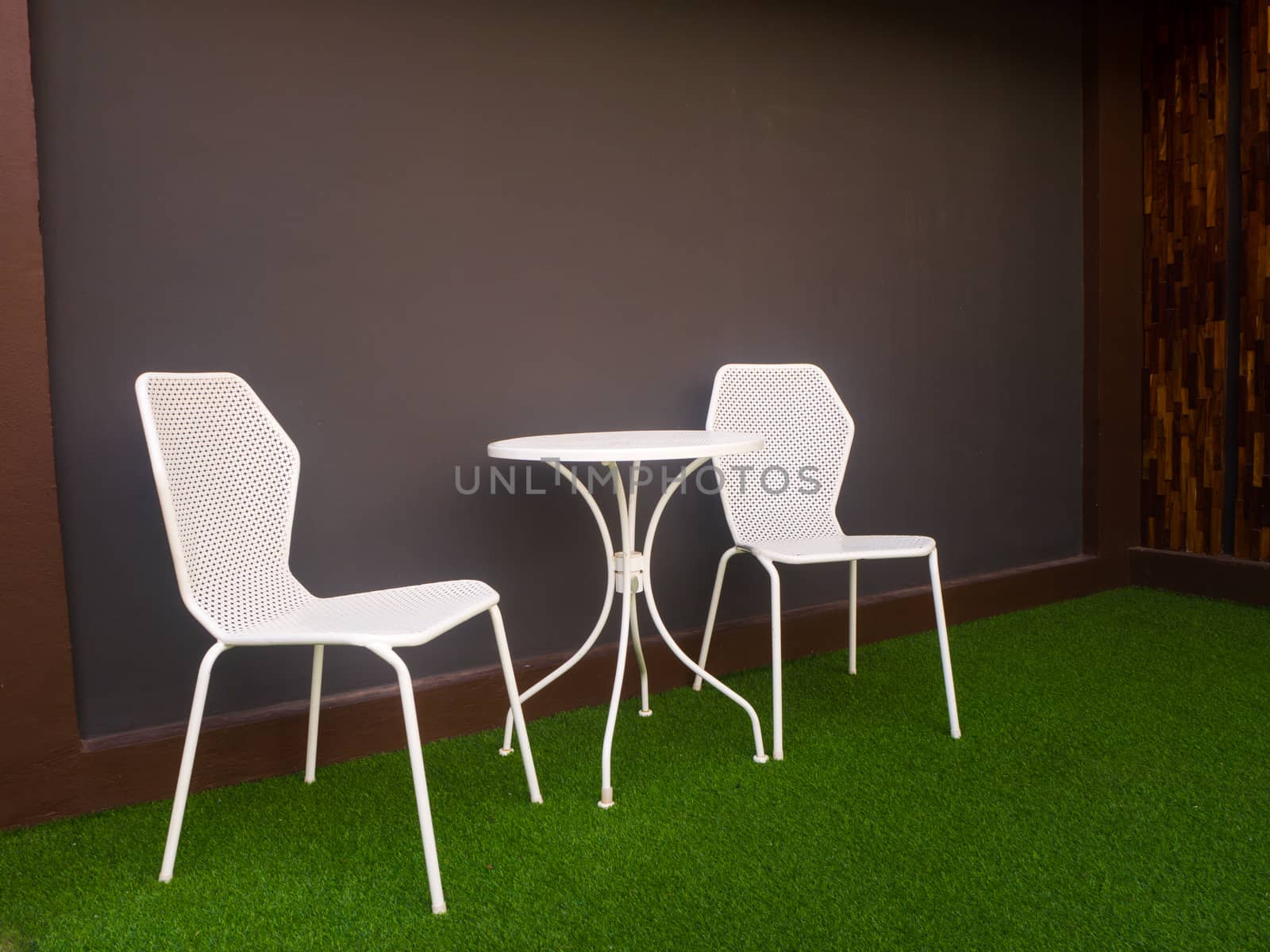 the tables and chairs in front of soft blue wall - Image