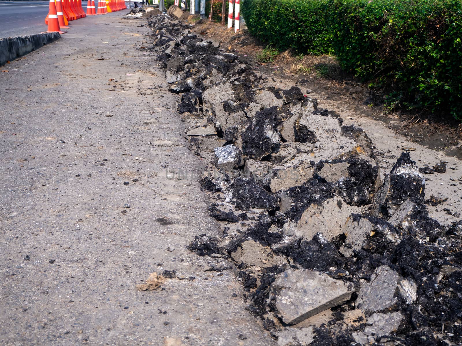 the Road repairing works with jackhammer. machine drills asphalt