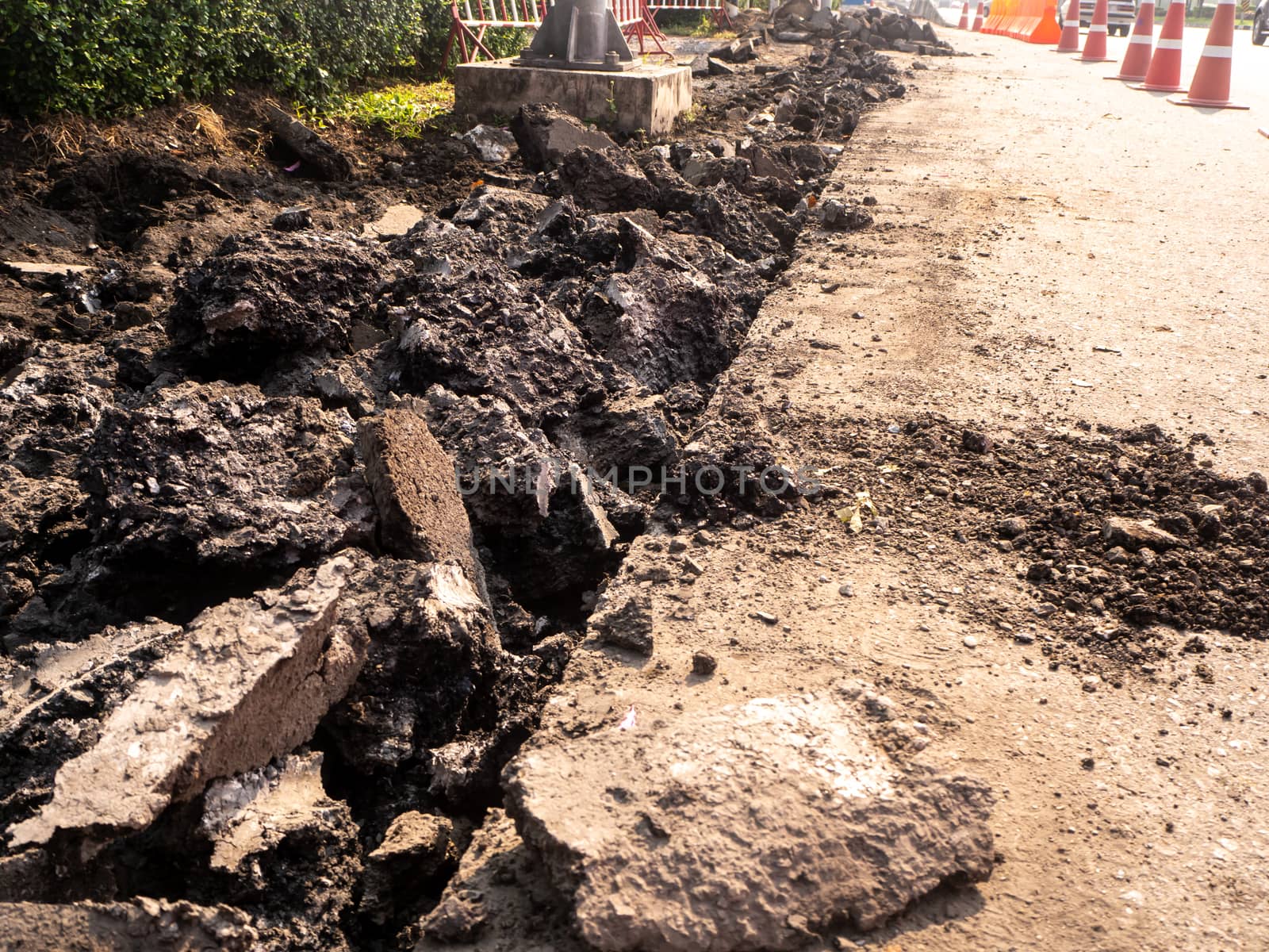 the Road repairing works with jackhammer. machine drills asphalt