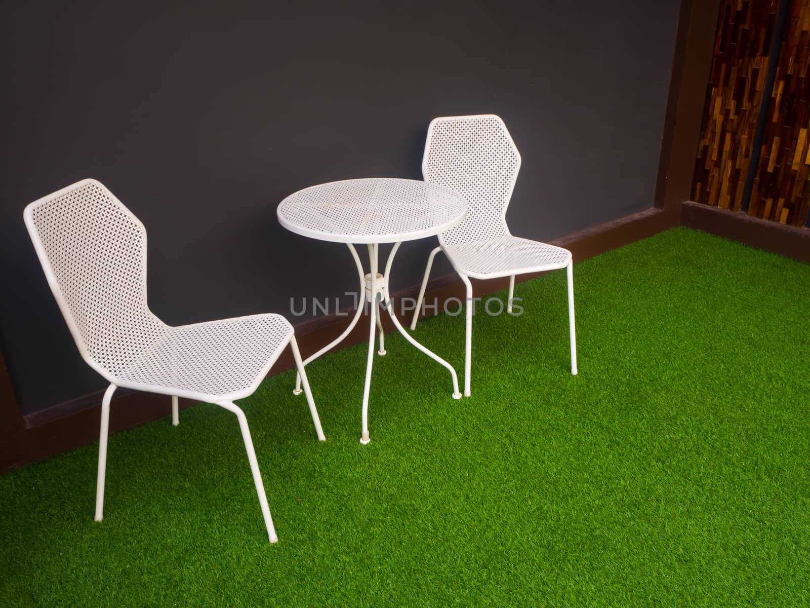 the tables and chairs in front of soft blue wall - Image