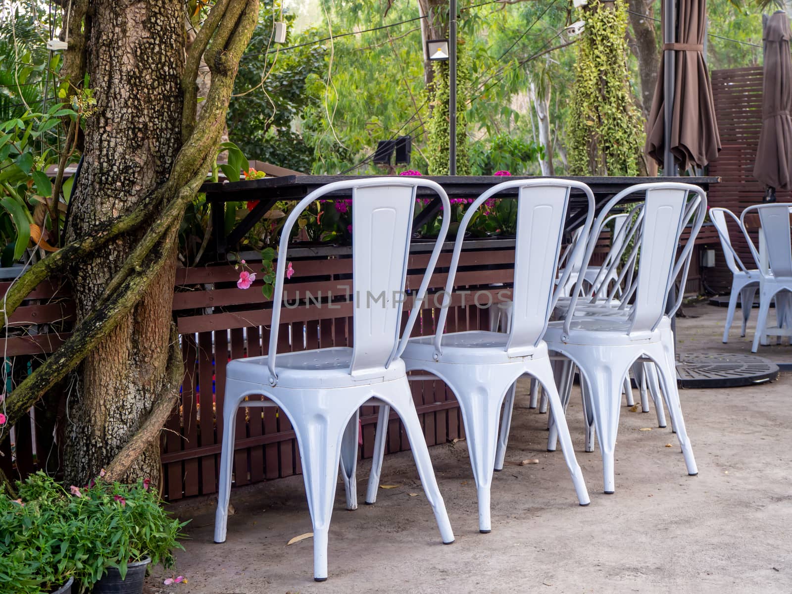 table and chairs standing on a lawn at the garden