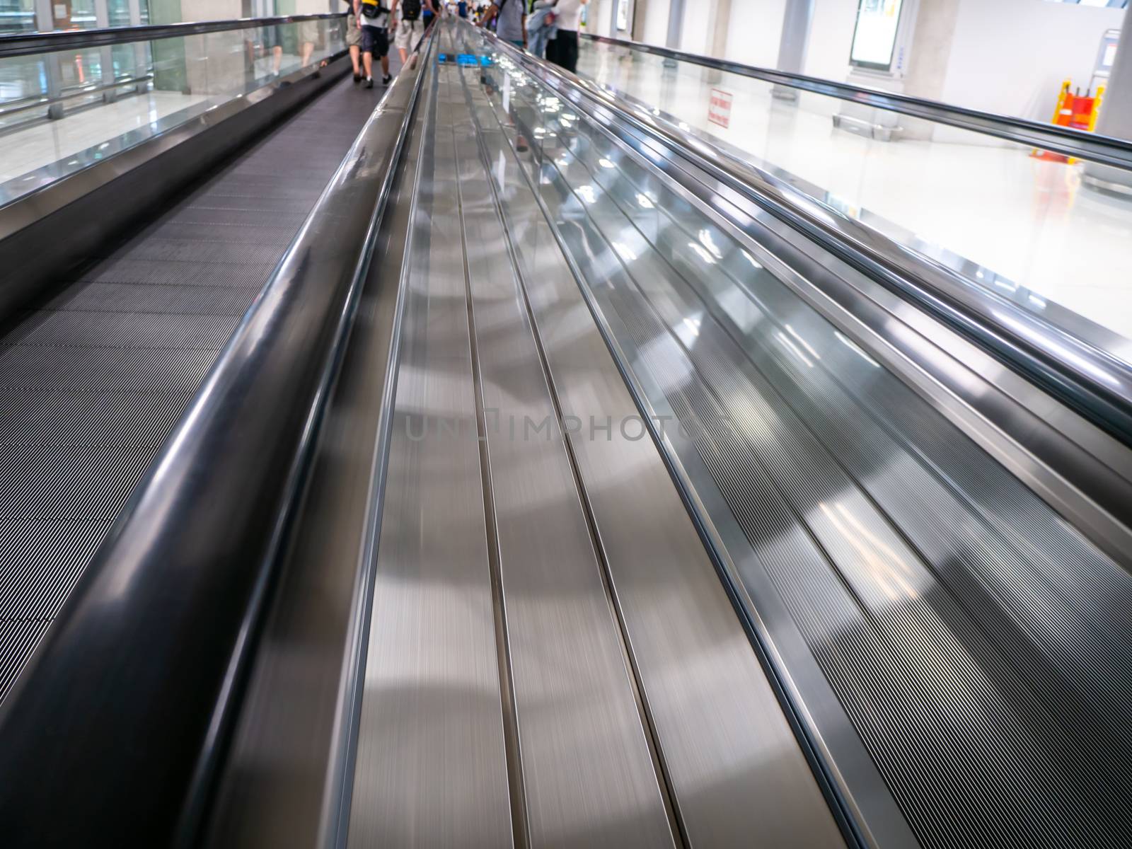 The skywalk with blurred business people in airport