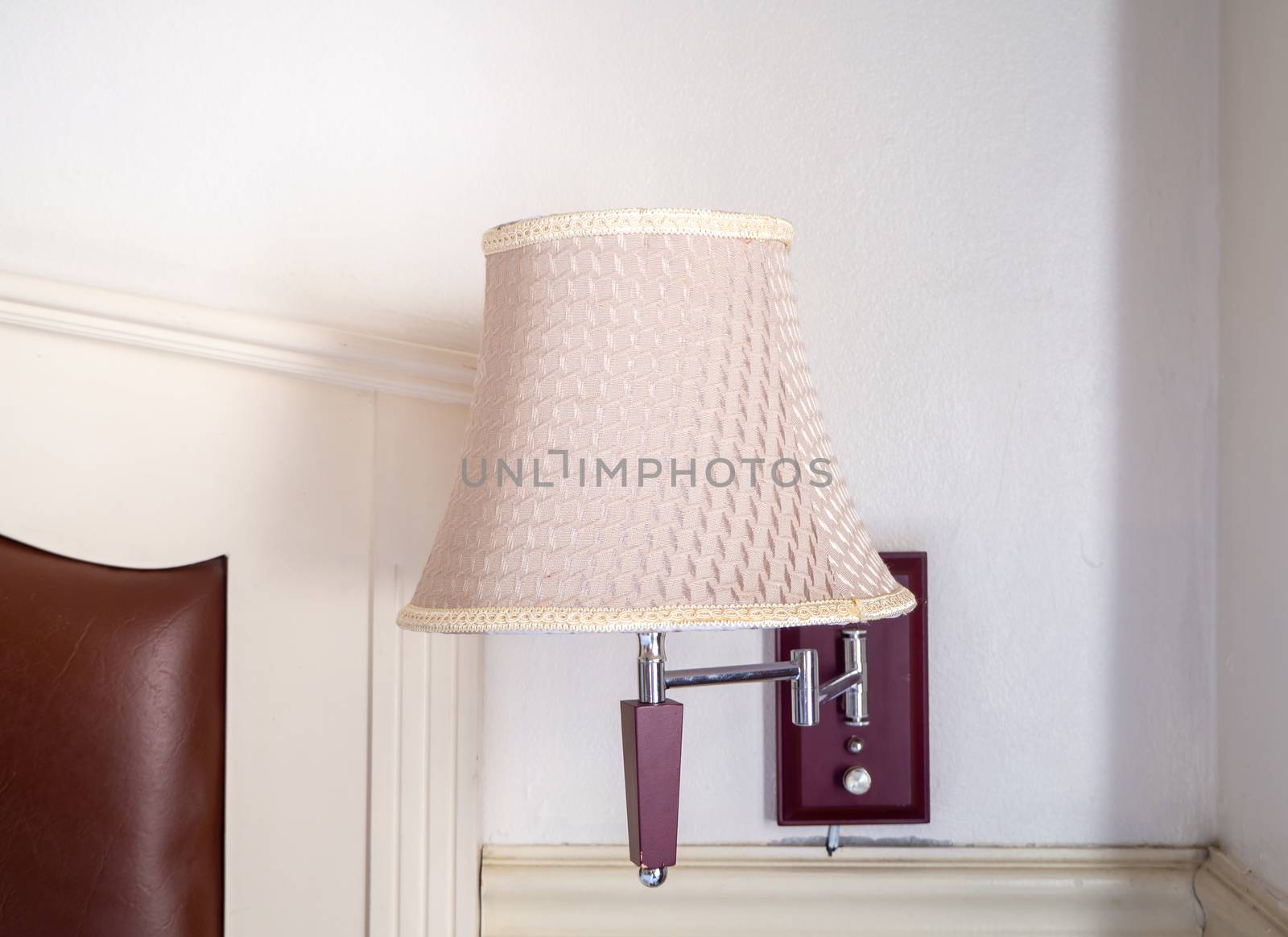 bedroom interior with pillows and reading lamp on bedside table