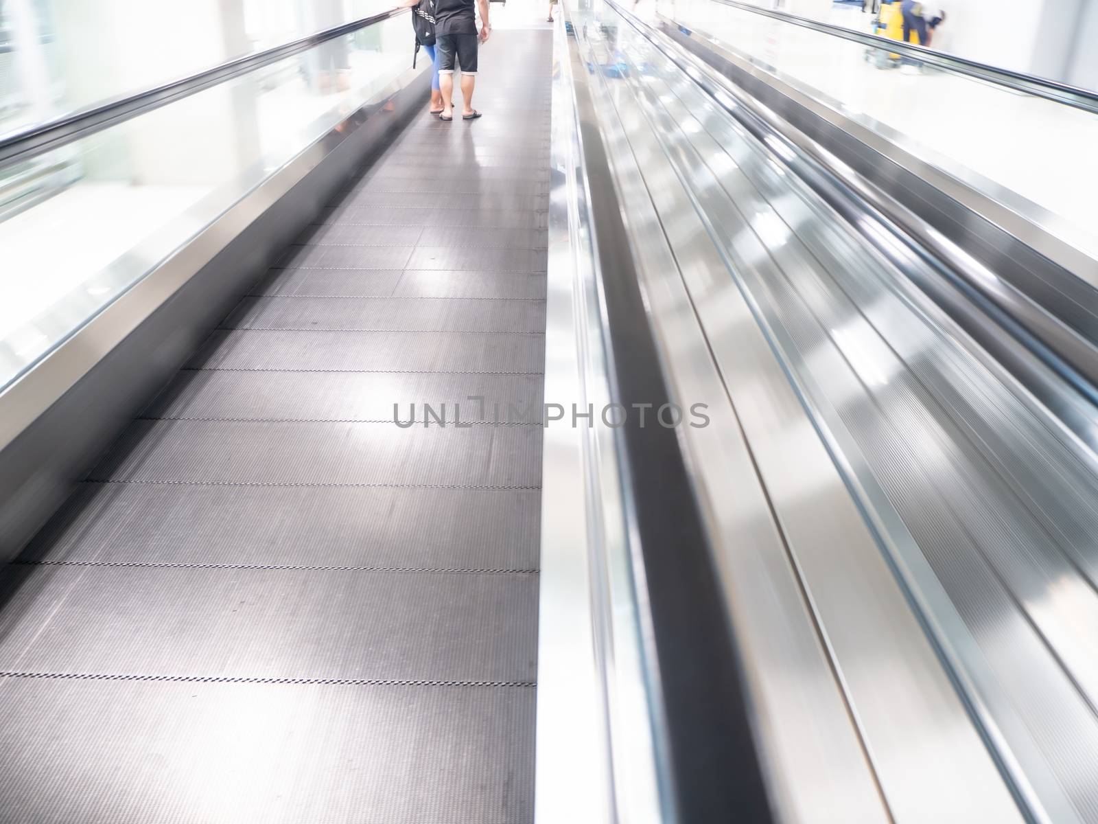 The skywalk with blurred business people in airport