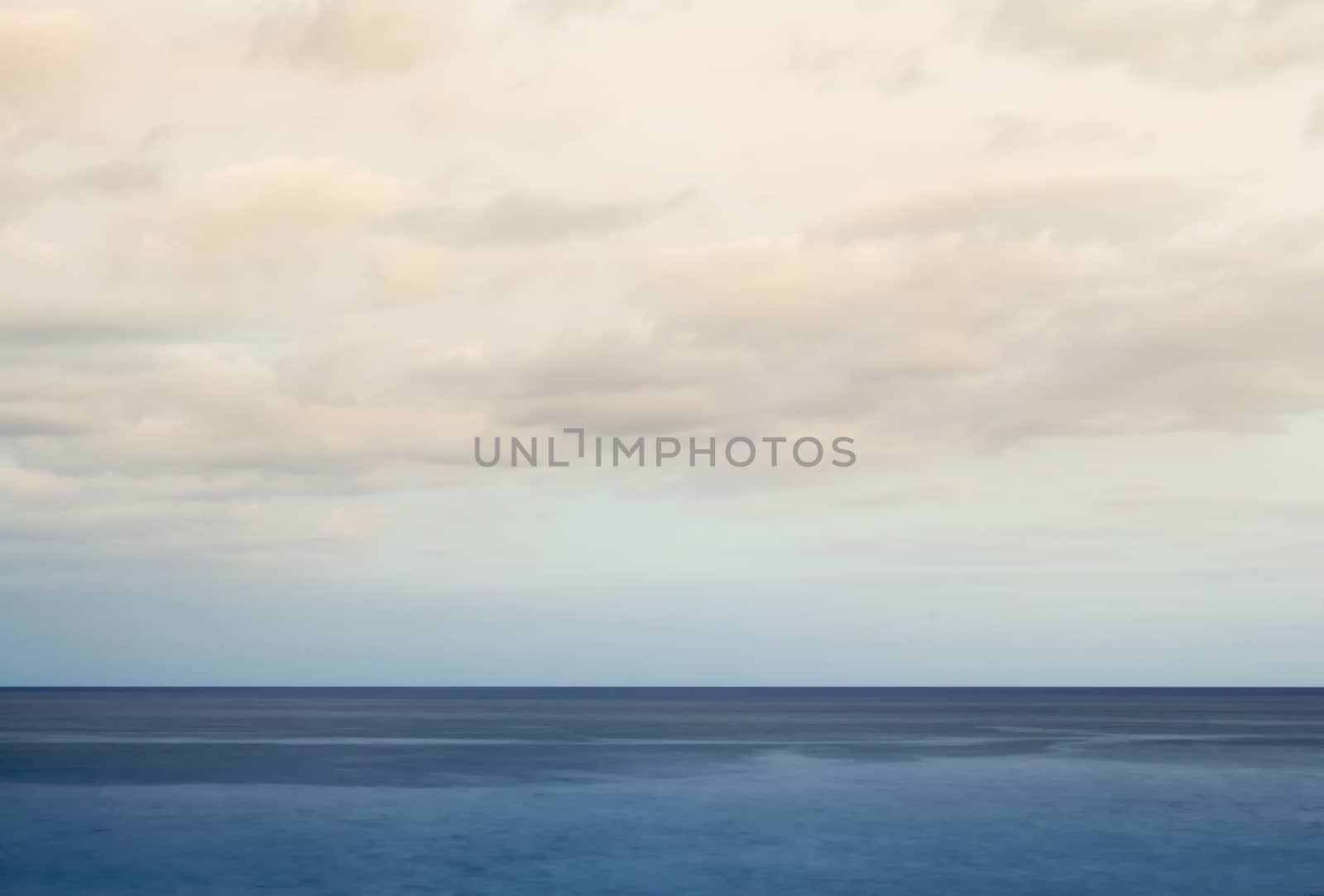 Minimalist seascape with blue waters and cloudy sky