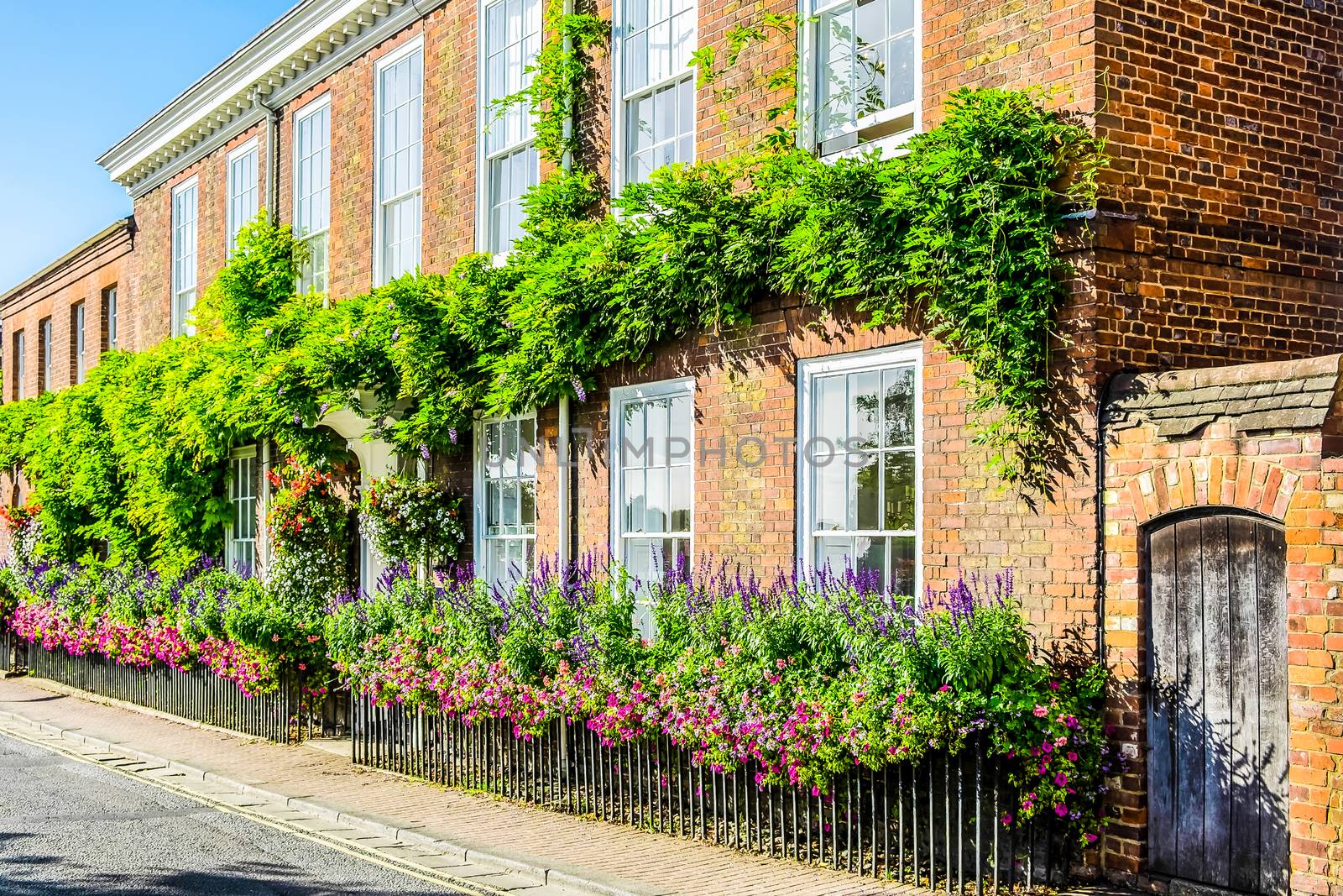 England Henley on Thames Sept 27 2016 red brick house with beautiful hanging baskets and window box