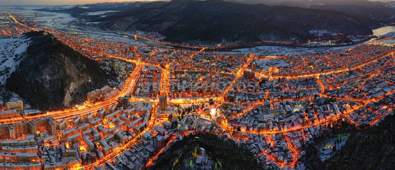 Aerial view of city lights in winter evening. Aerial panorama of Piatra Neamt in Romania