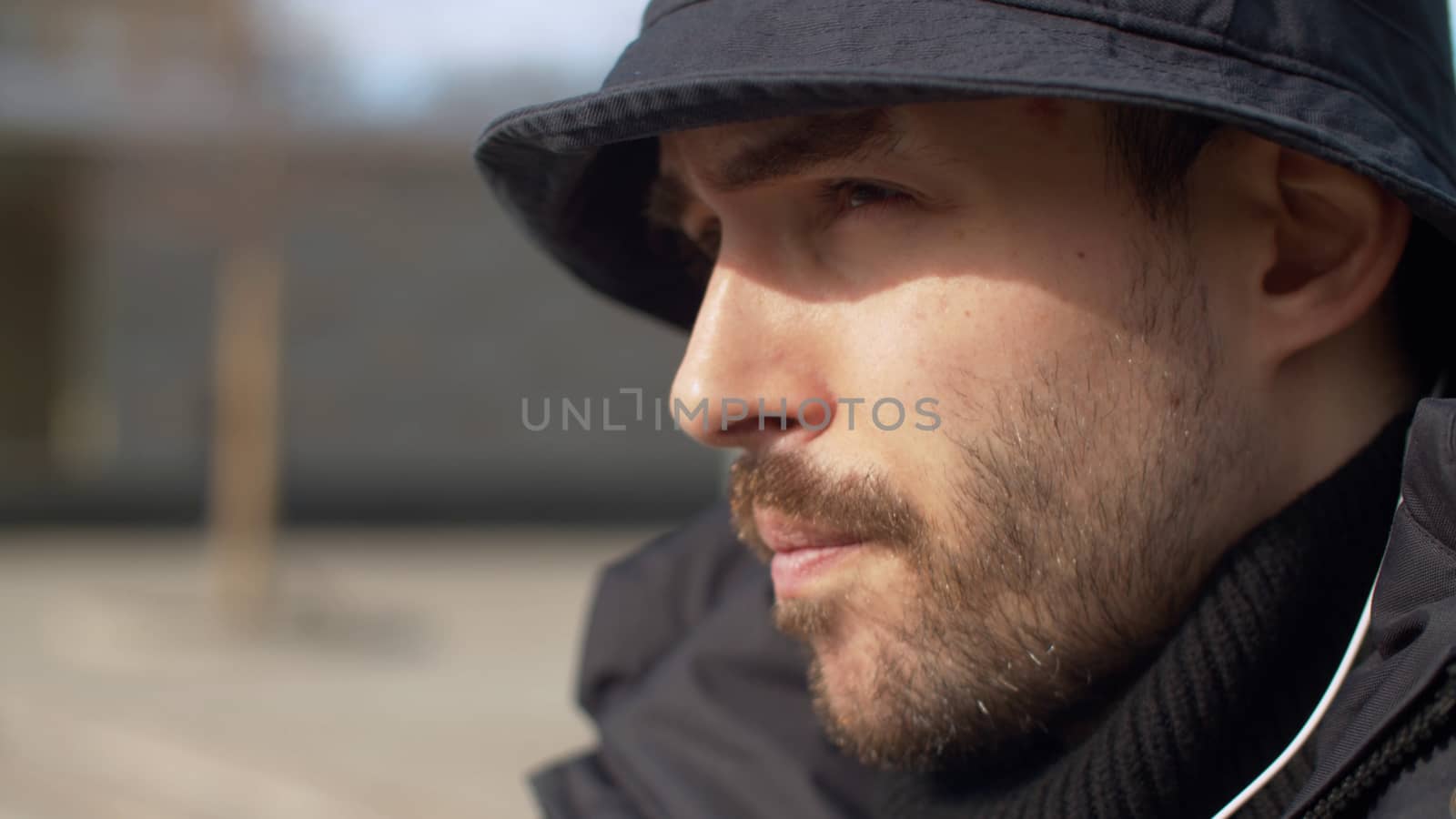 Close up portrait of a young handsome man outdoors in spring.