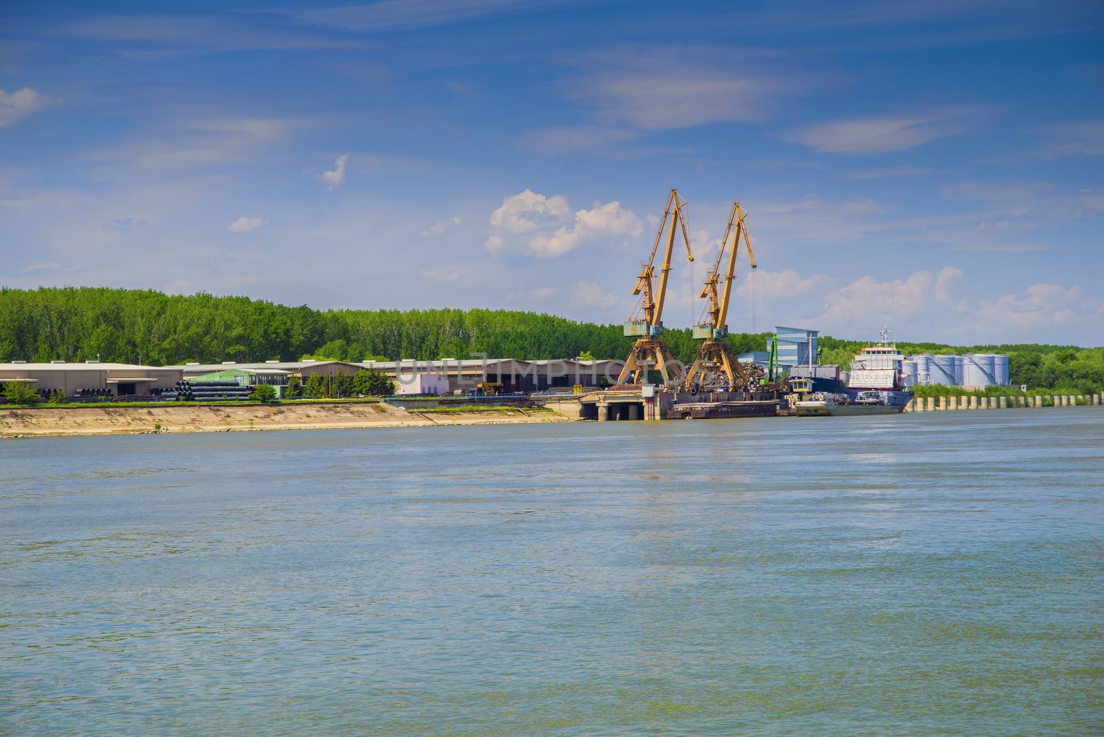 Shipyard with cranes on Danube river by savcoco