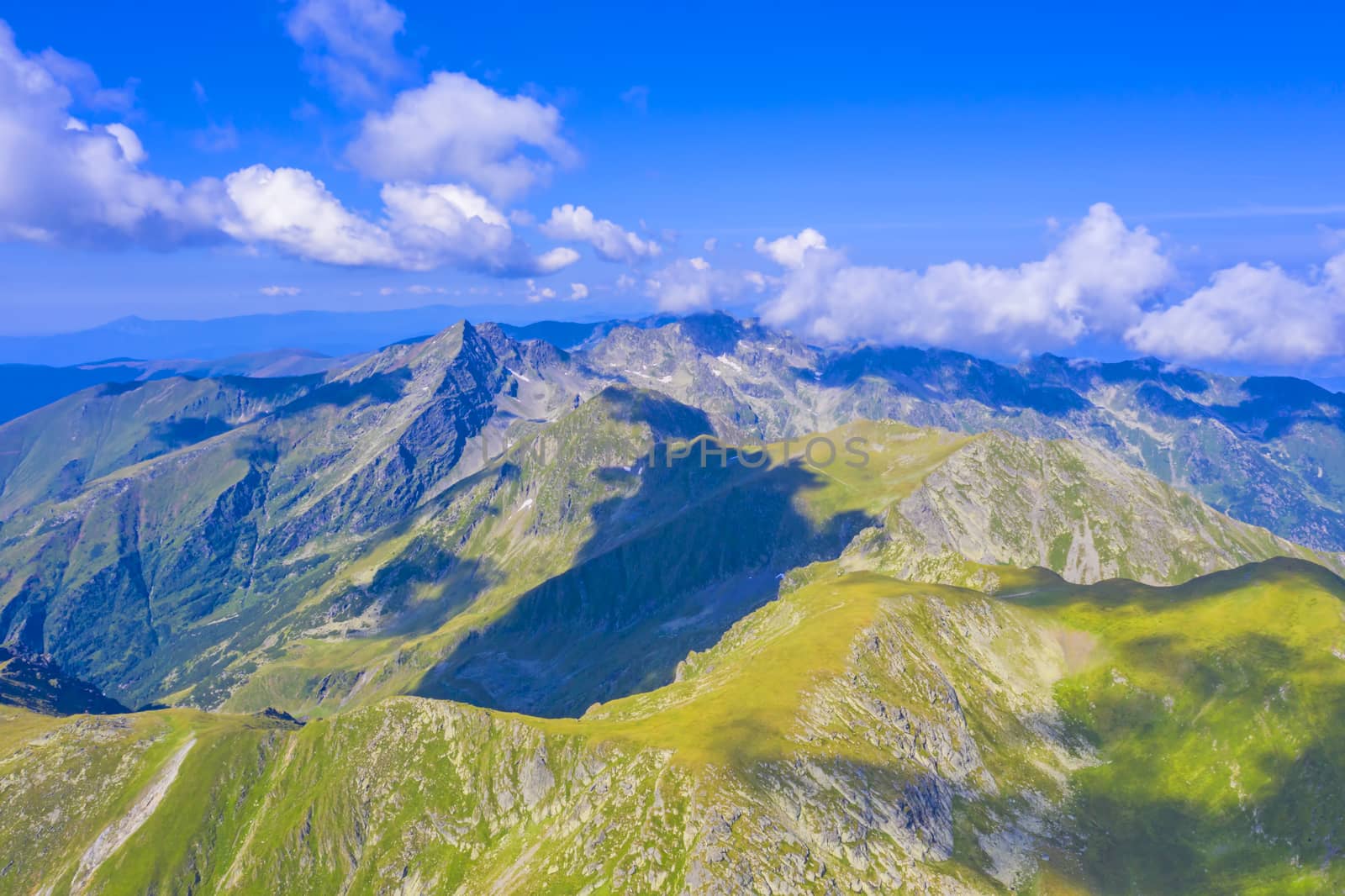 Summer mountain scene, green crest and clouds in Romanian Carpathians