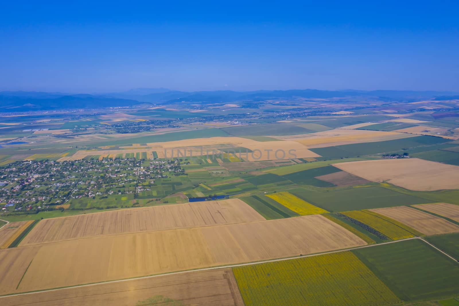 Aerial view of summer fields and village, rural landscape