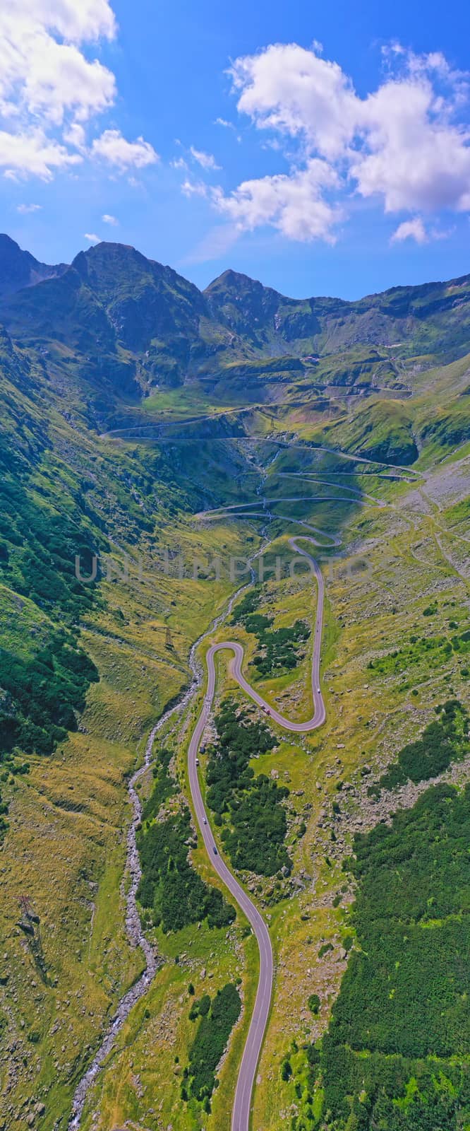 Aerial view in Romanian Carpathians, summer mountain winding road uphill
