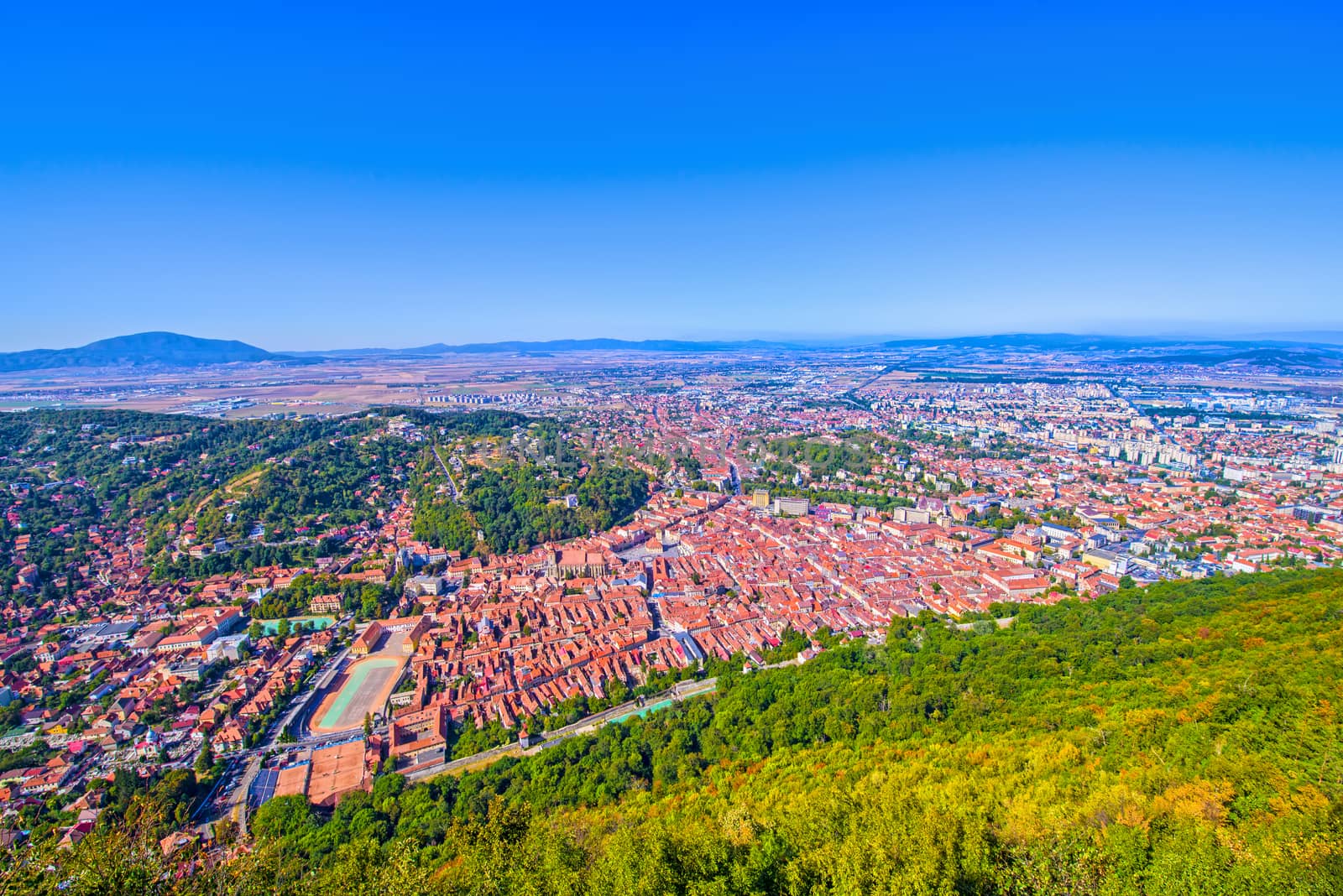 Panoramic view of Brasov city from the top, summer aerial scene in Romania