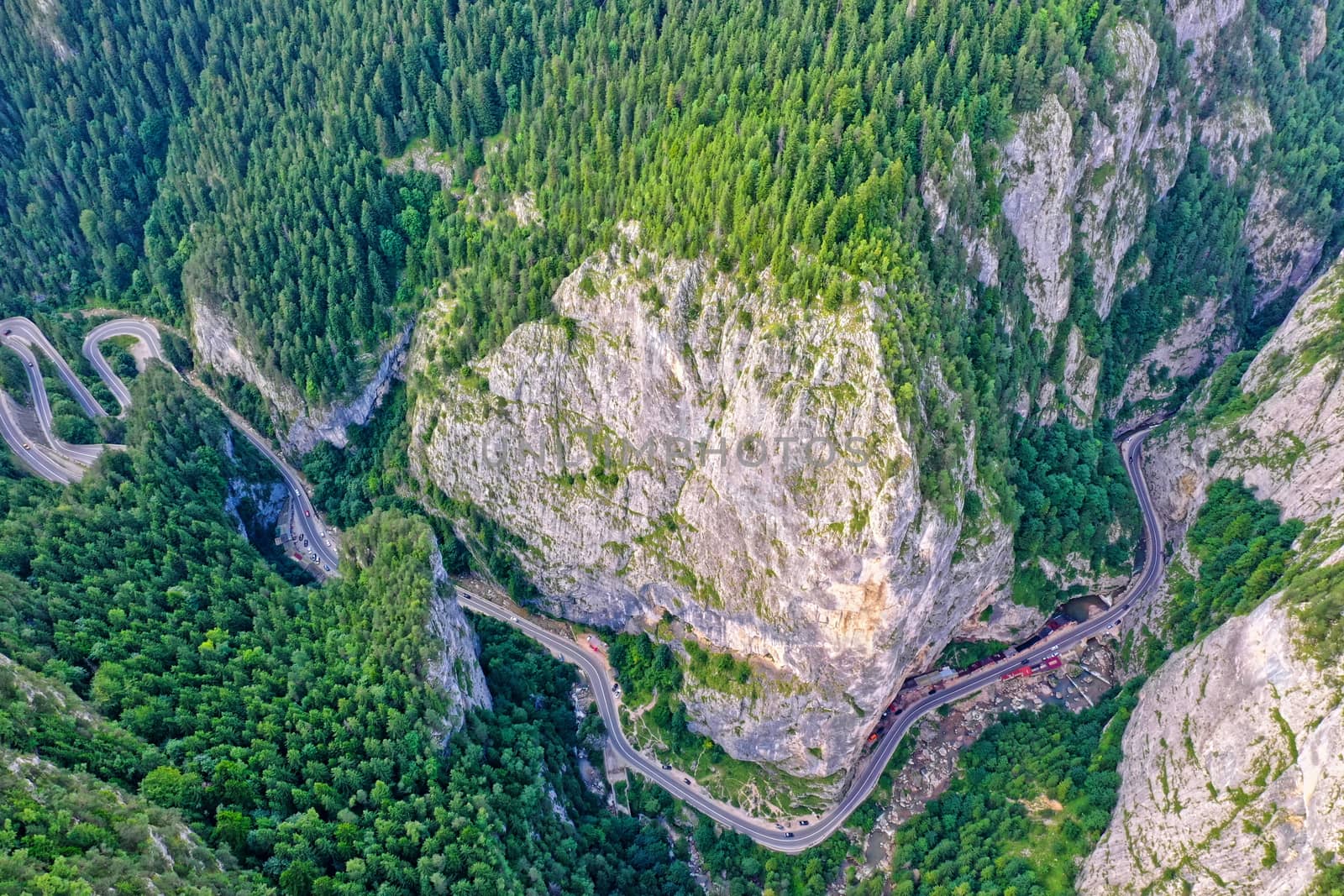 Above view of winding forest road, mountain pass in Romanian Carpathians