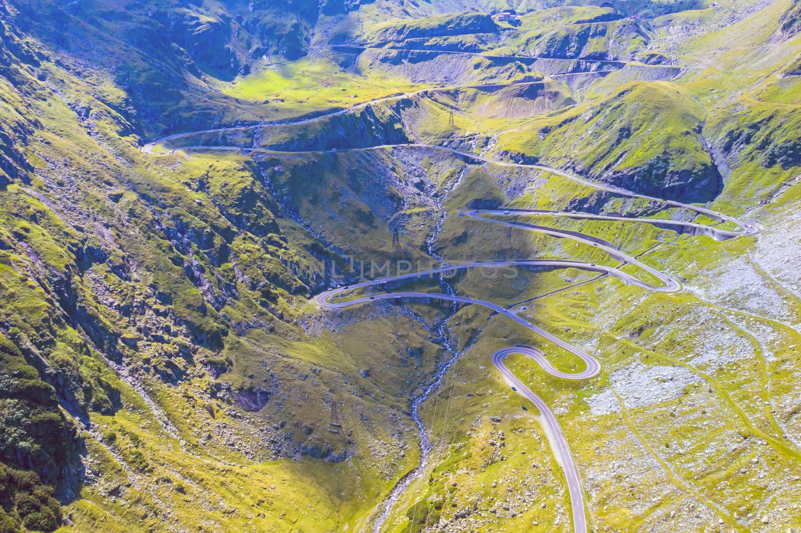Winding road uphill  on mountain, aerial view of Transfagarasan road in Romania