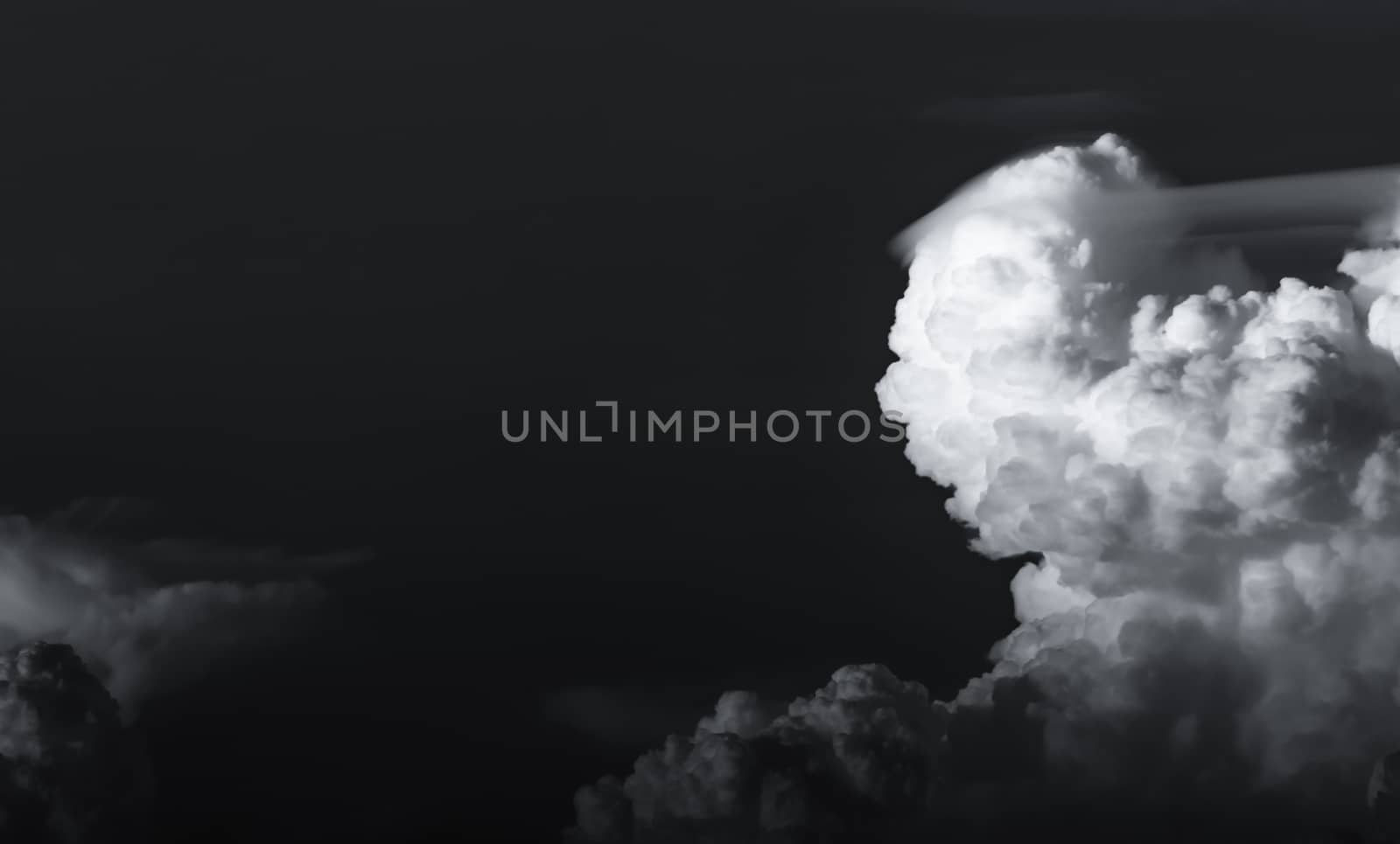 Dark dramatic sky and clouds. Background for death and sad concept. Black sky and white fluffy clouds. Sad and moody sky. Beauty in nature. Dead abstract background. Beautiful pattern of clouds.