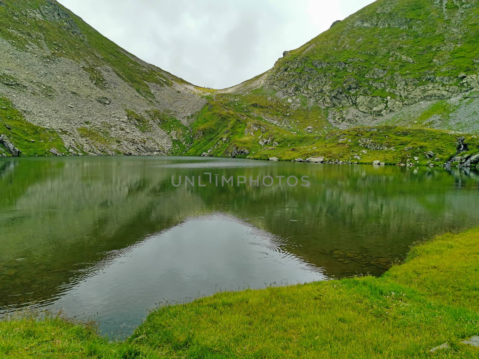 Glacier Capra Lake in Romanian Carpathians, clear mountain lake