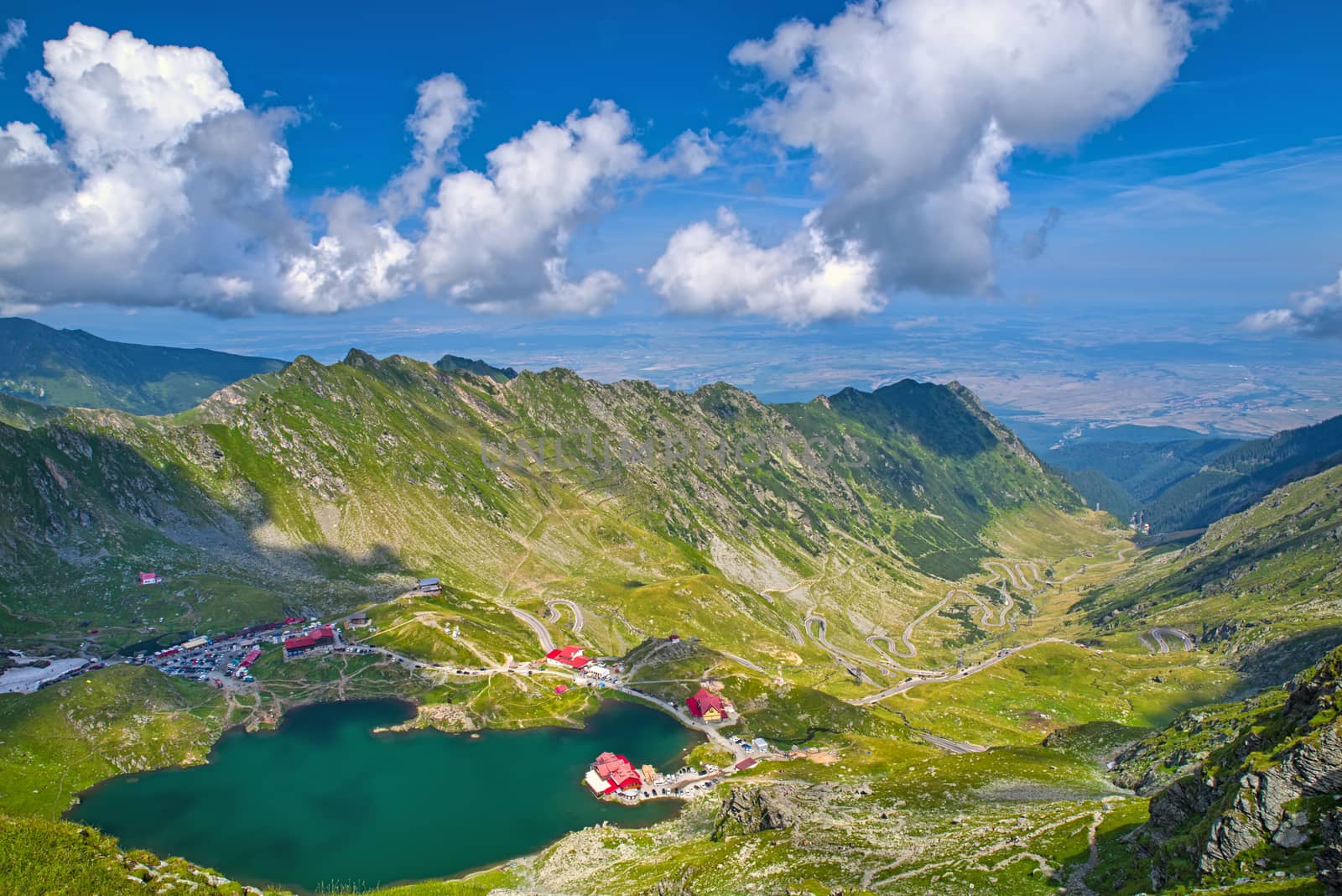 Balea lake and Transfagarasan road seen from above in the summer, landscape in Romanian Carpathians, Fagaras rocky mountains