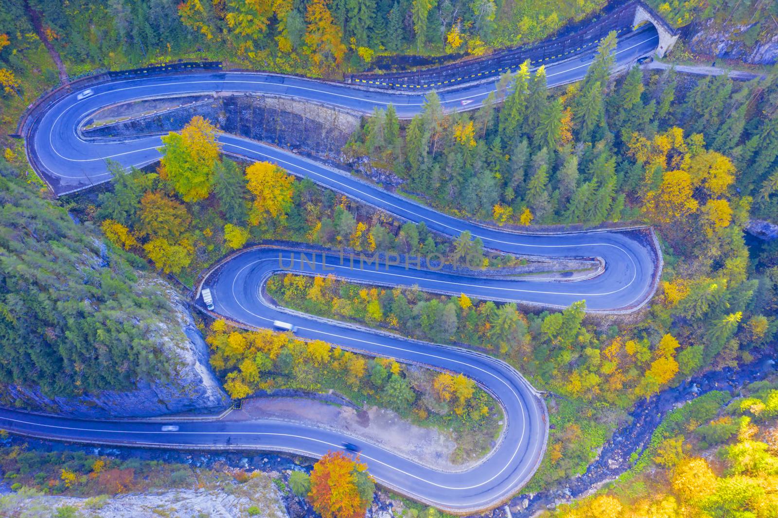 Above view of winding road in autumn forest. Bicaz Gorges are a mountain pass between two historic region in Romania.