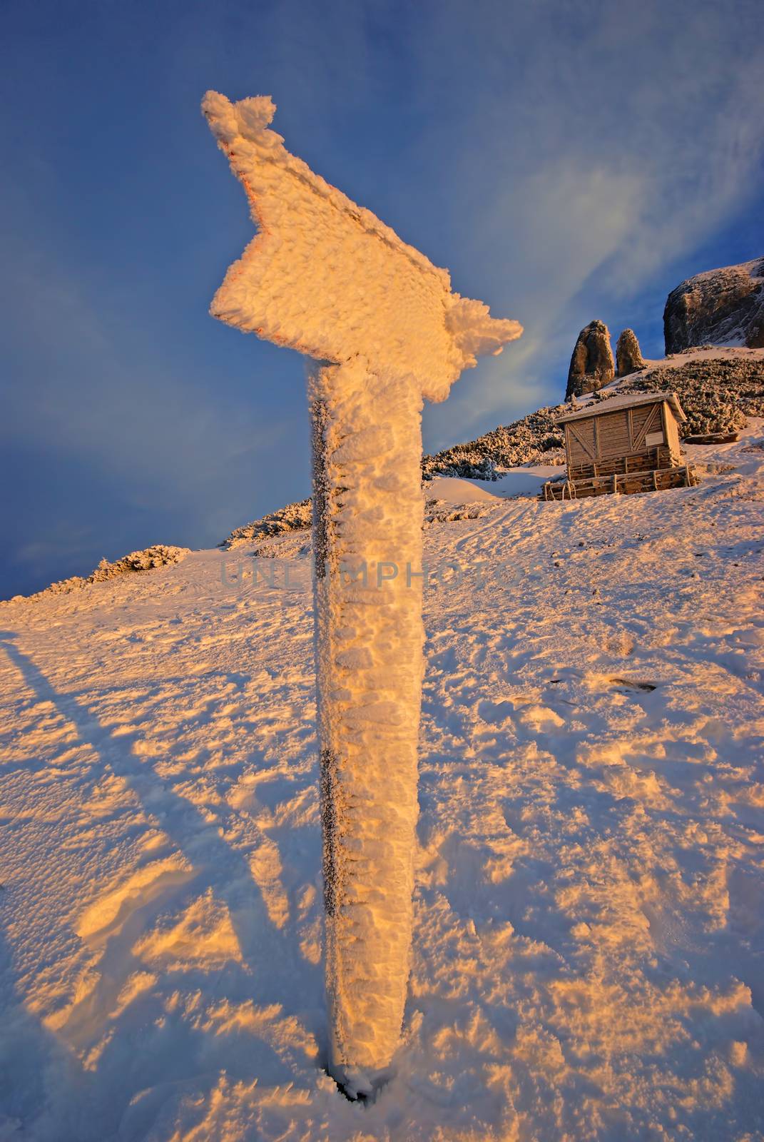 Frozen mountain signpost on mountain during winter by savcoco