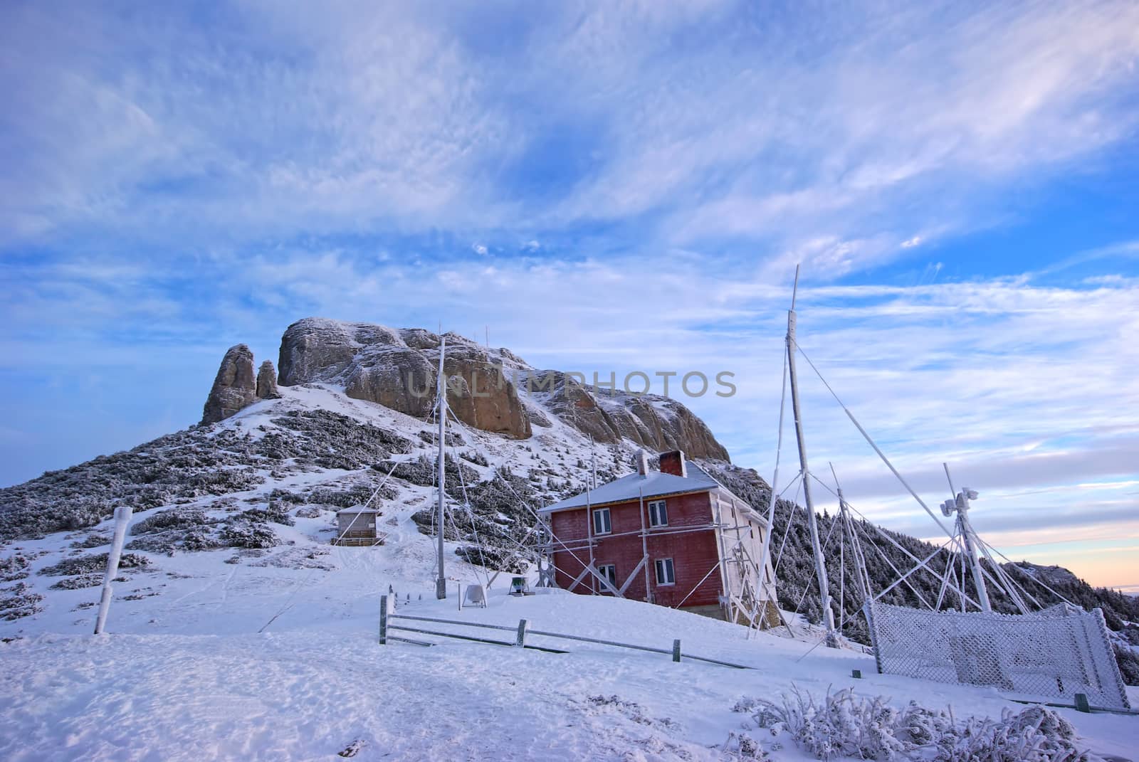 Frozen chalet and winter scene on mountain by savcoco