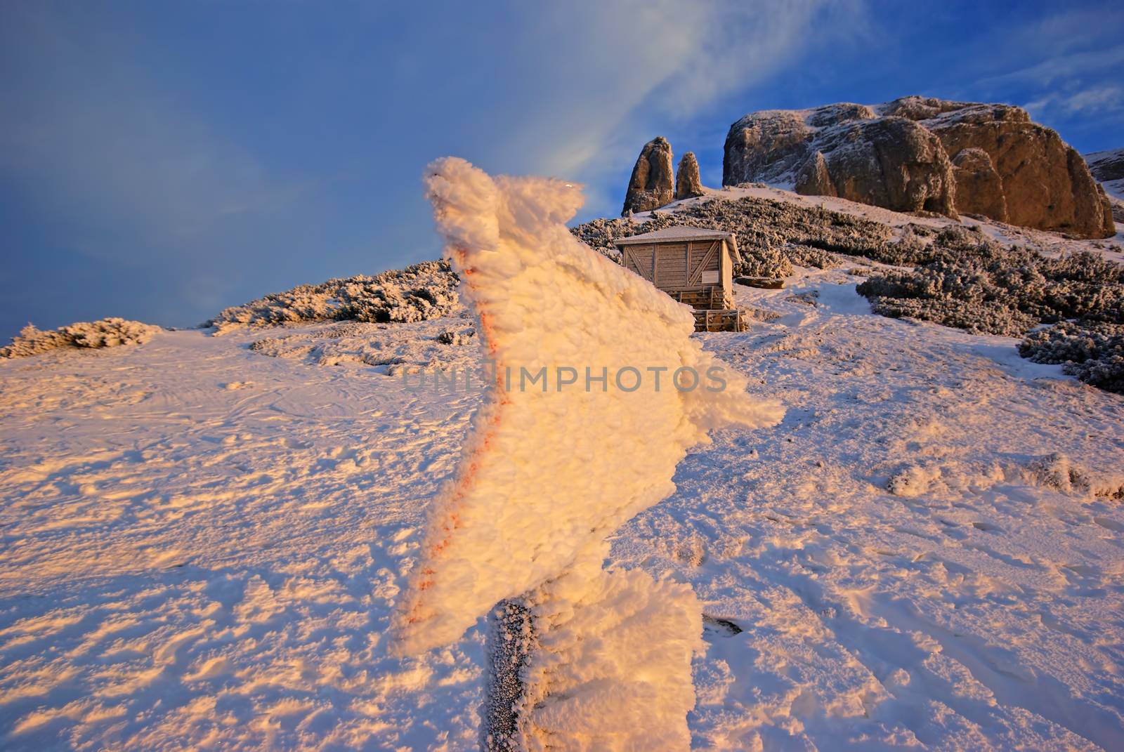 Romanian Carpathians frozen signpost, snowy indicator on the mountain
