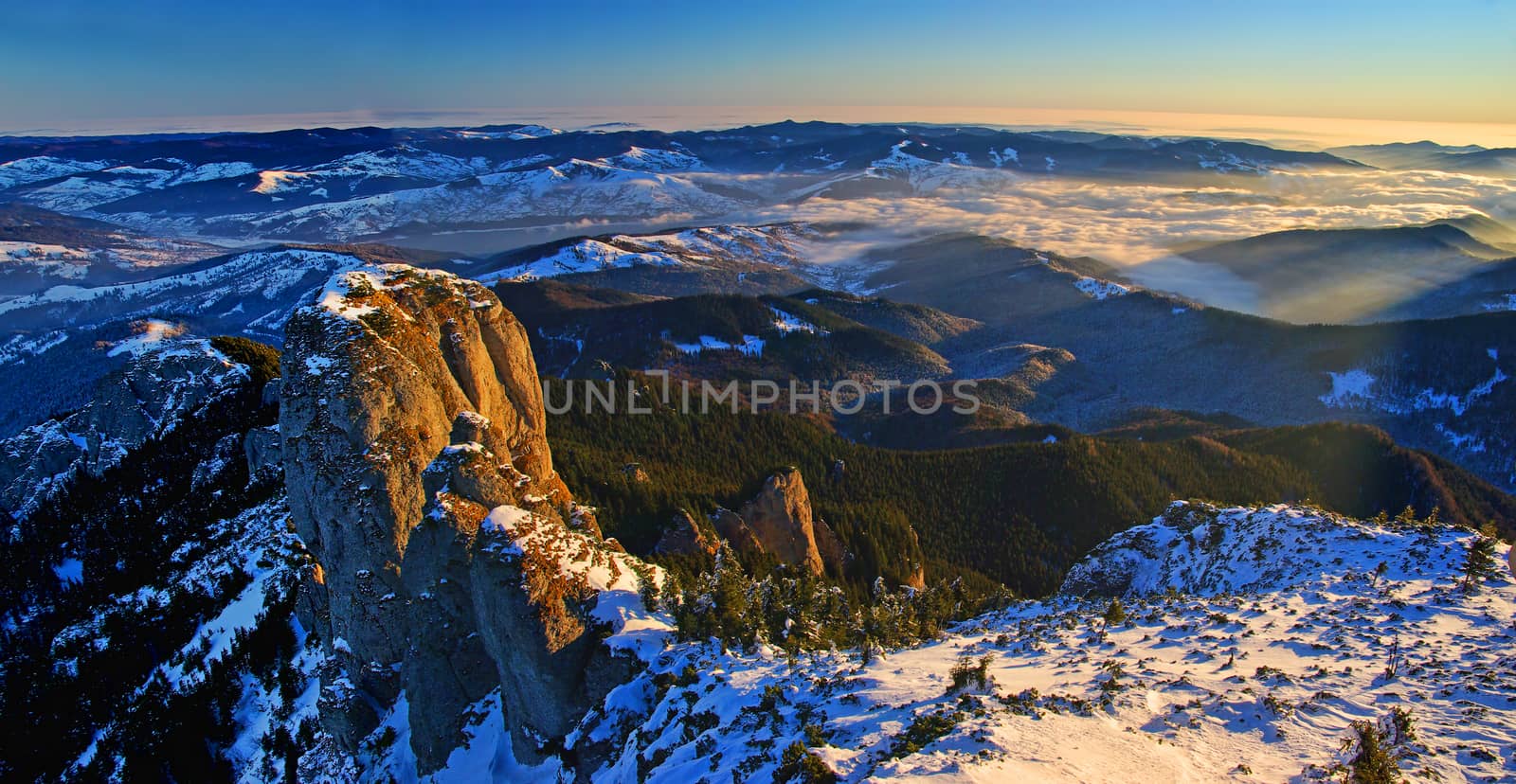 Mountain panorama from the top in winter, aerial panorama in Romanian Carpathians.