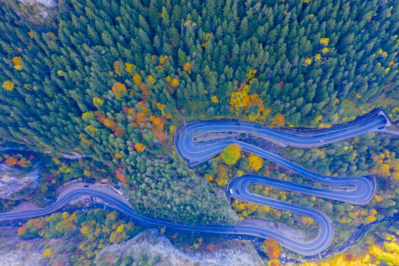 Above view of winding road in autumn forest. Bicaz Gorges are a mountain pass between two historic region in Romania.