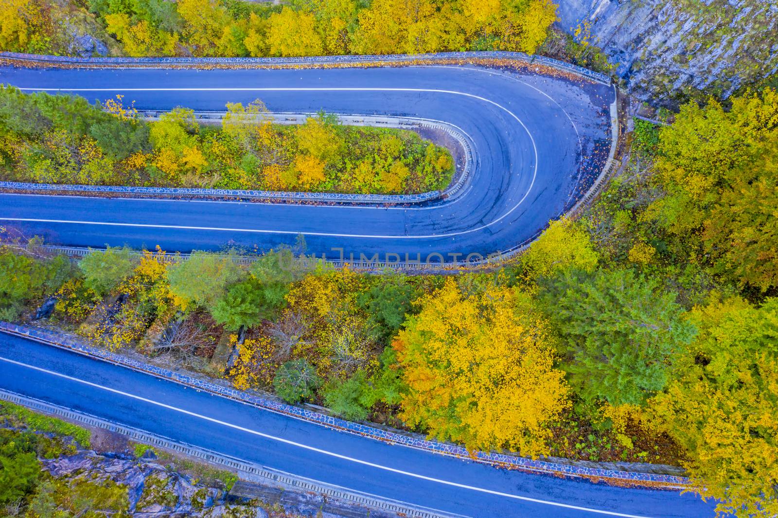 Mountain road in colored forest. Bicaz Gorges are a mountain pass between two historic region in Romania.