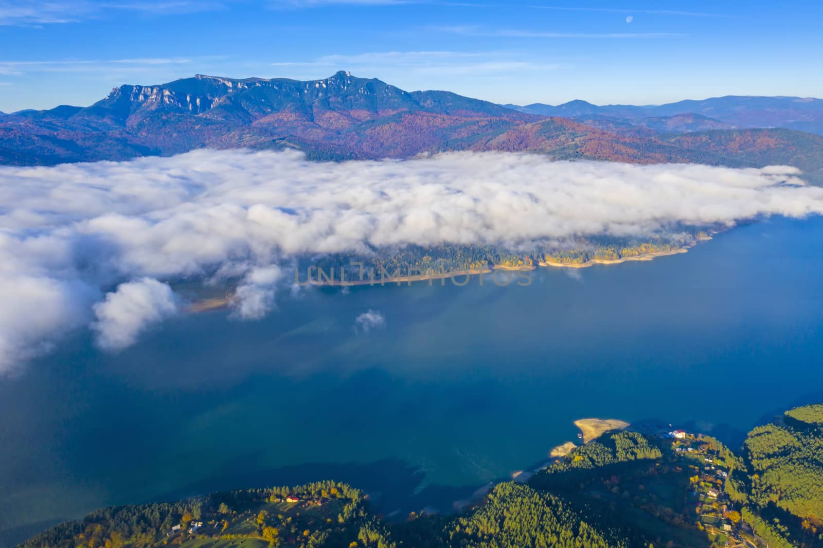 Floating mist cloud in autumn landscape, Bicaz Lake in Romanian Carpathians