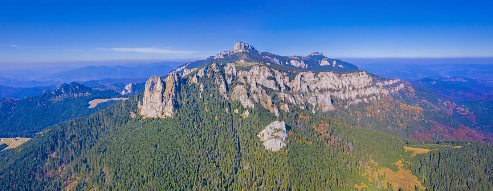 Aerial autumn landscape in Romanian Carpathians, rocky mountain and autumn forest landscape