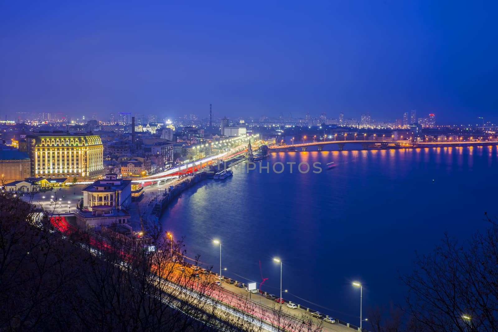 Aerial night view of Dnieper river, Havana Bridge  and historic district of Podil in Kiev