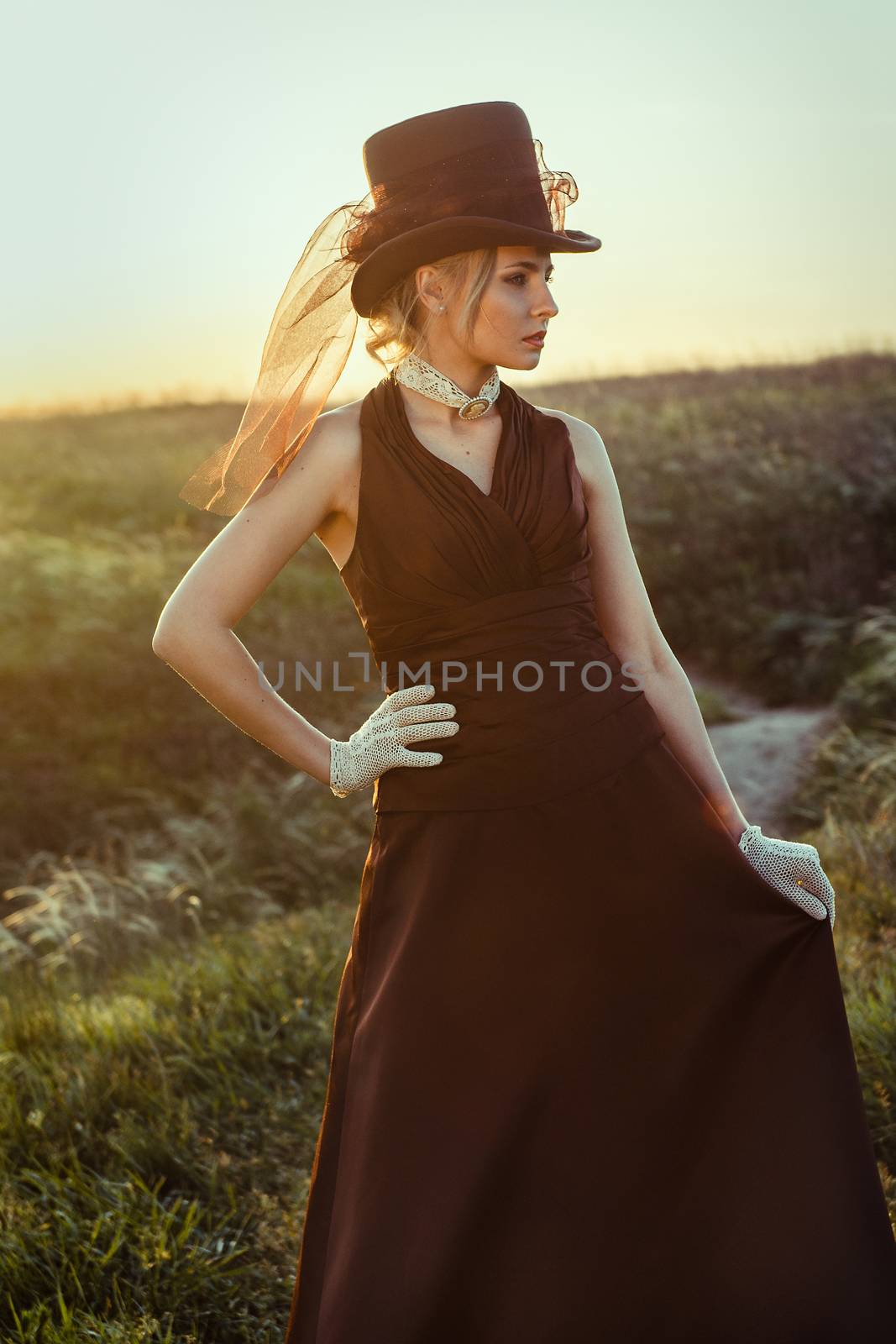 young blonde girl in a brown vintage dress and top hat by Andreua