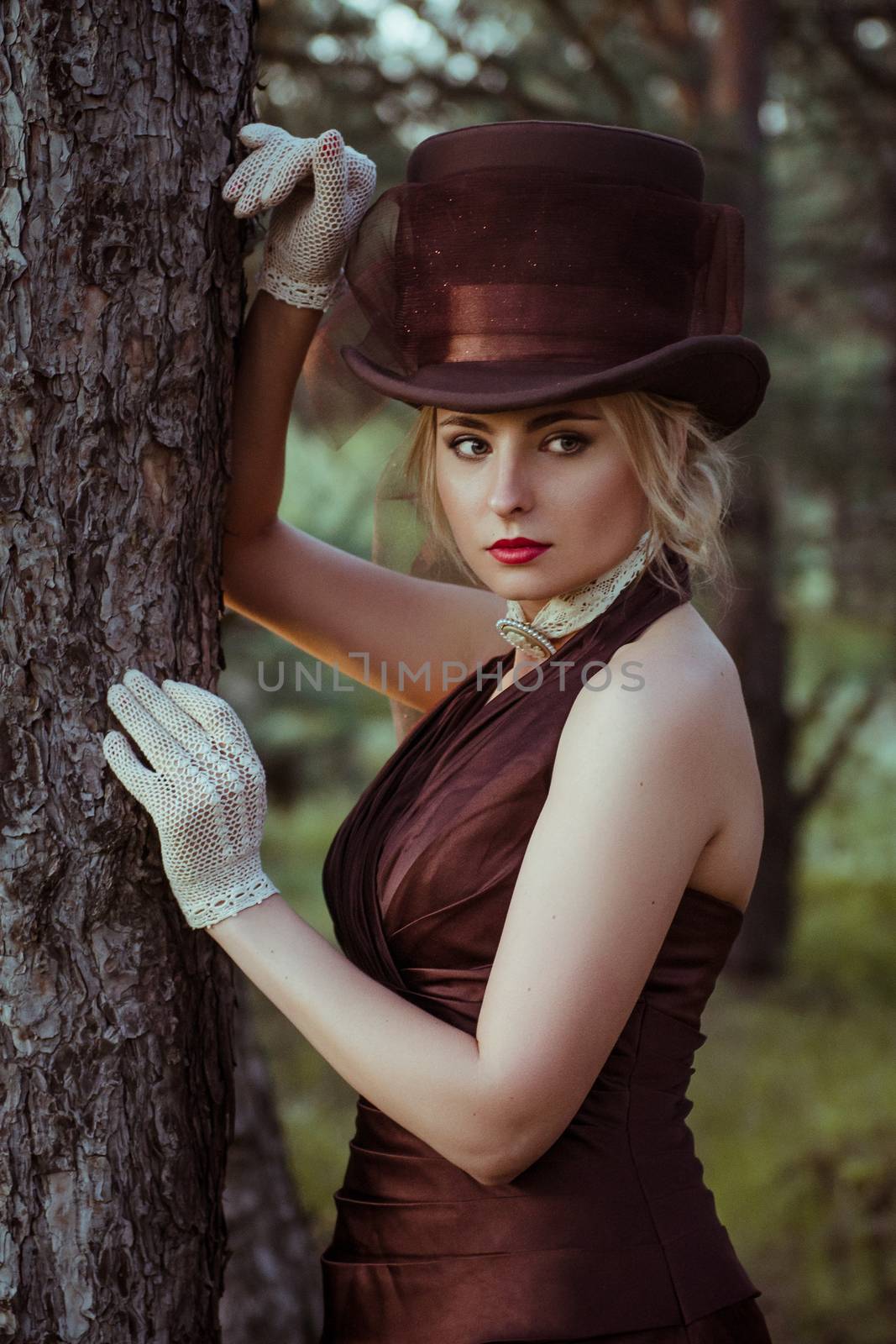 young blonde girl in a brown vintage dress and top hat by Andreua