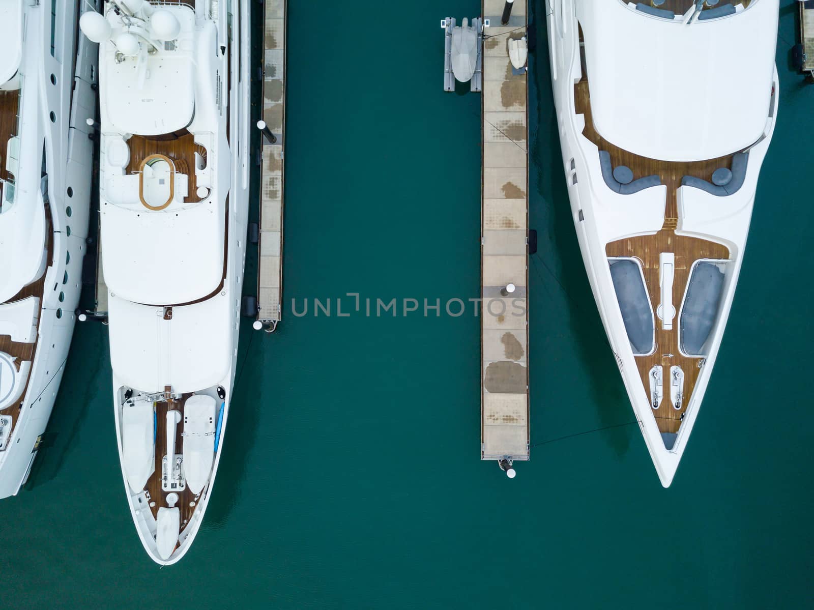 Aerial view of yachts in marina, detail shot, green sea water
