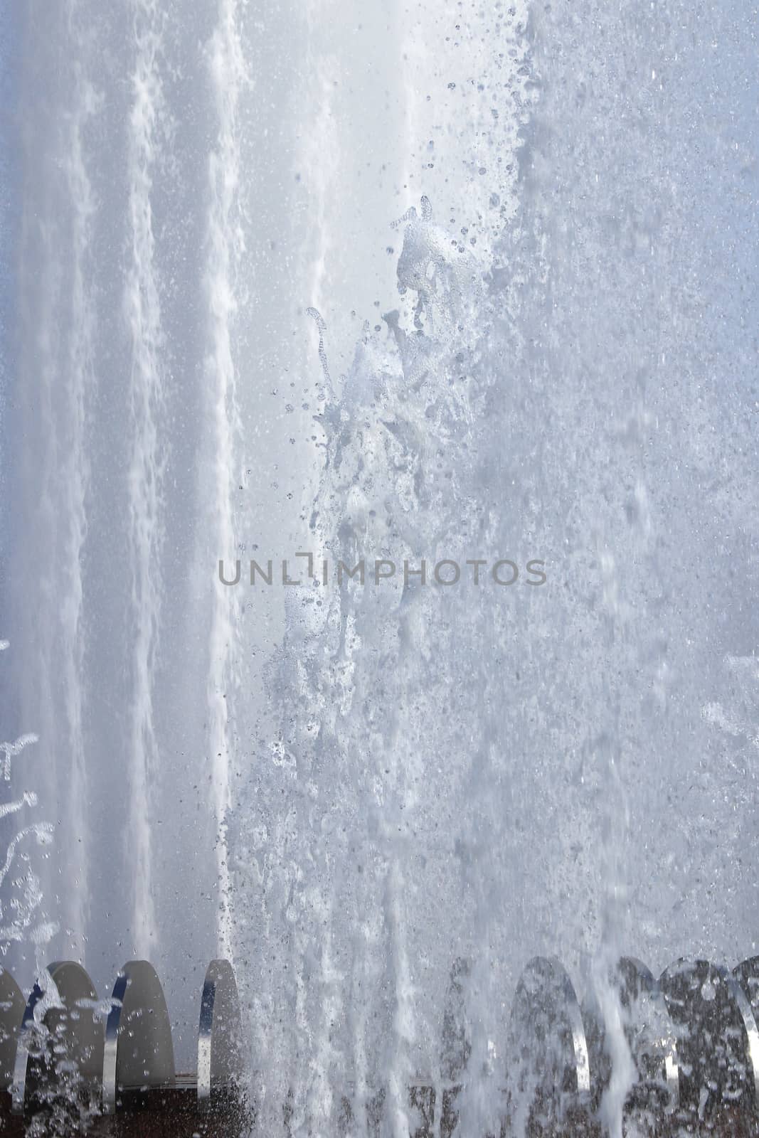 Wet spray summer waterfall background.