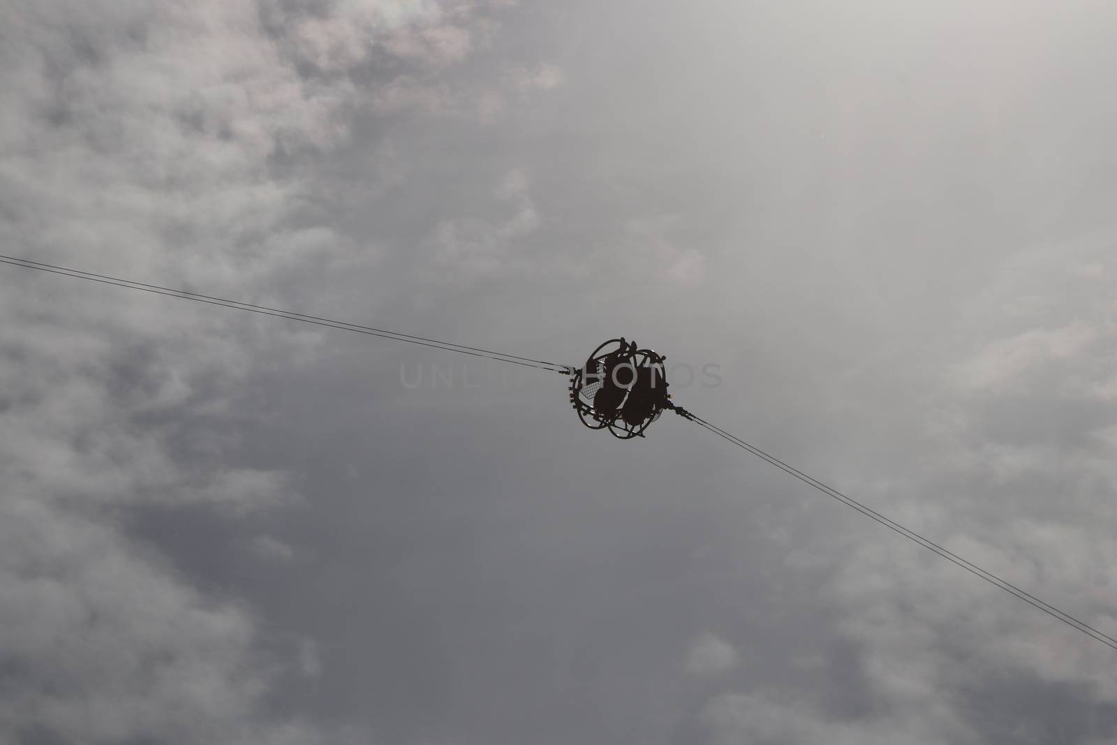 A capsule with two people is launched into the sky. Modern attraction. Amusement park Divo-island. Saint-Petersburg.