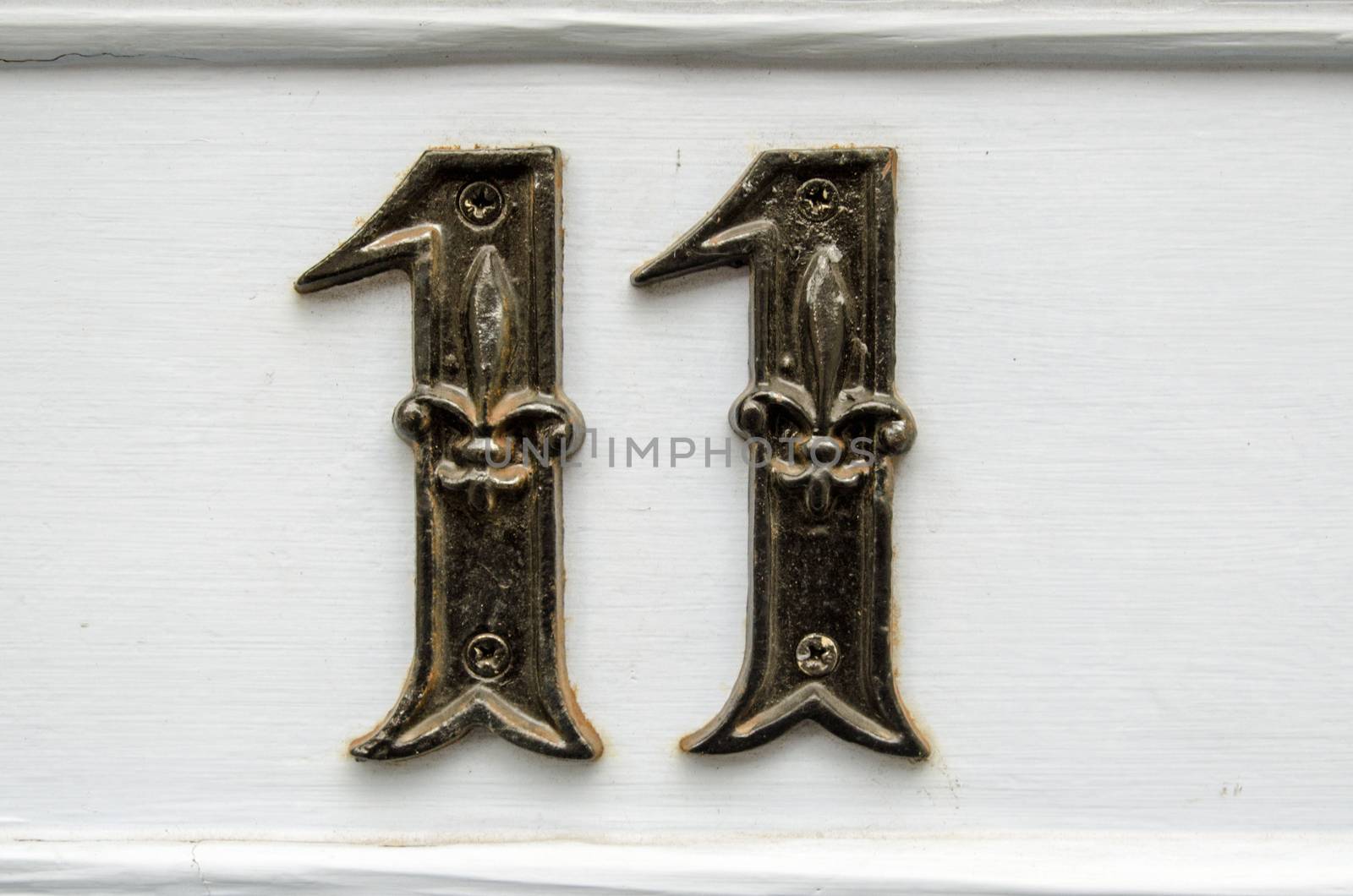 Number eleven screwed to the outside of a front door.