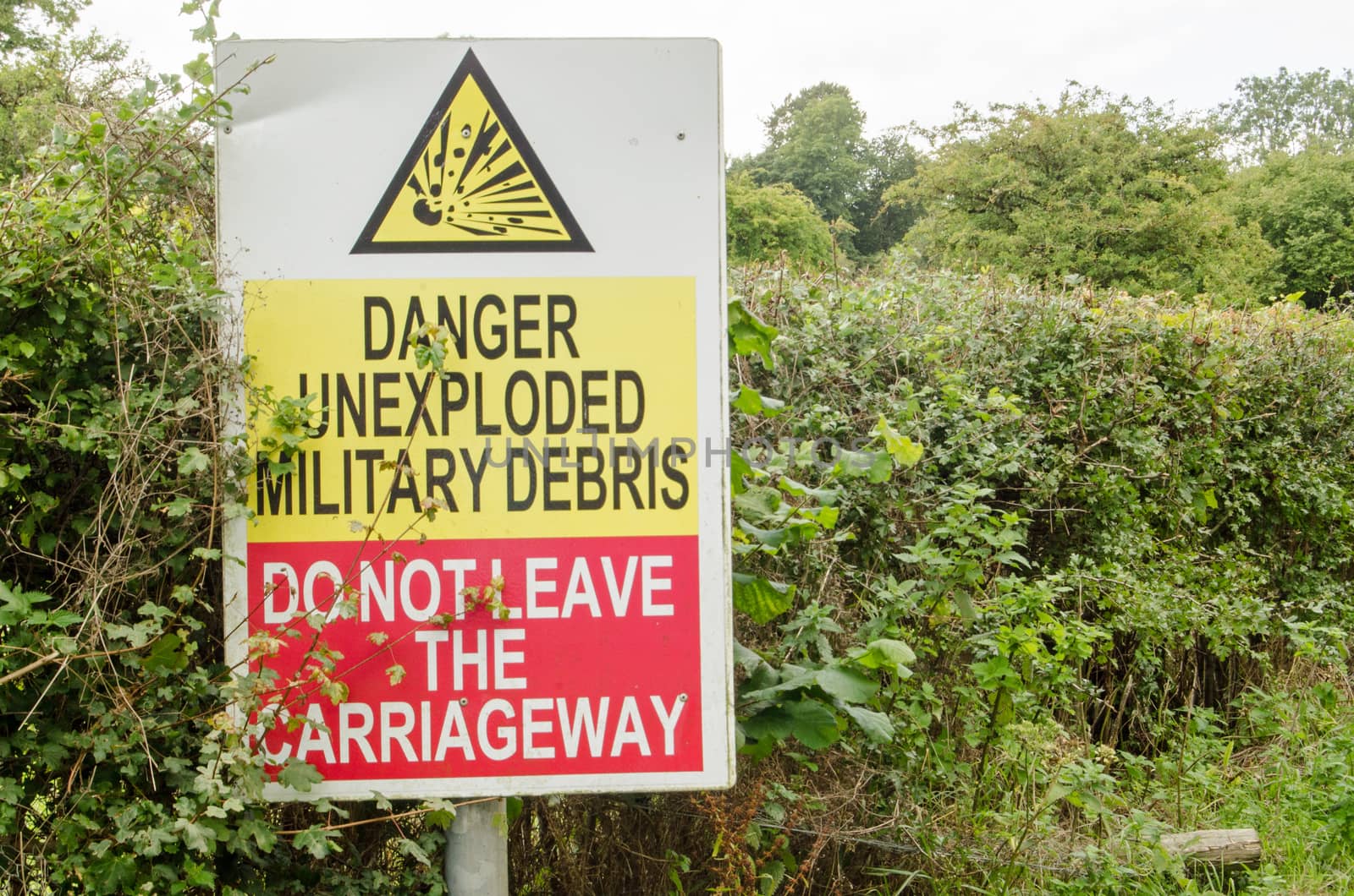 Sign beside a road on Salisbury Plain warning of unexploded ordnance.  The area is usually closed to visitors and is used by the British Army for training.