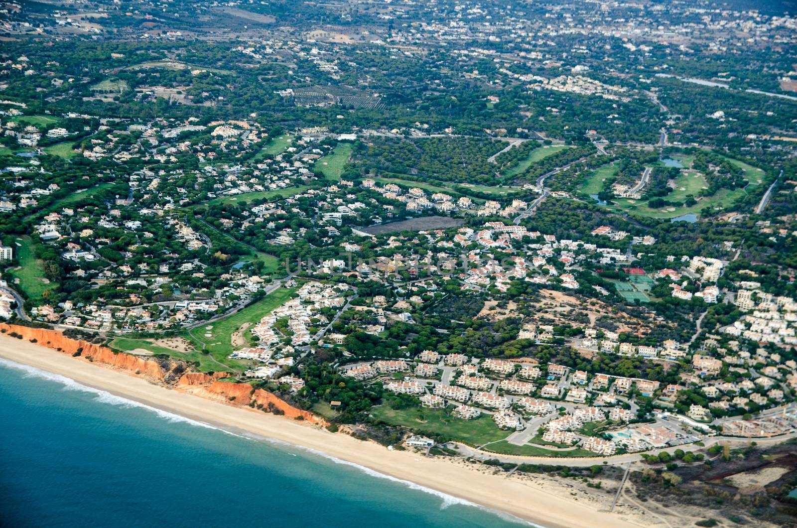 Aerial view of tourist resorts on the Algarve coast of Portugal with Praia de Vale Do Lobo, Quarteira and Praia do Garrao Poente visible.