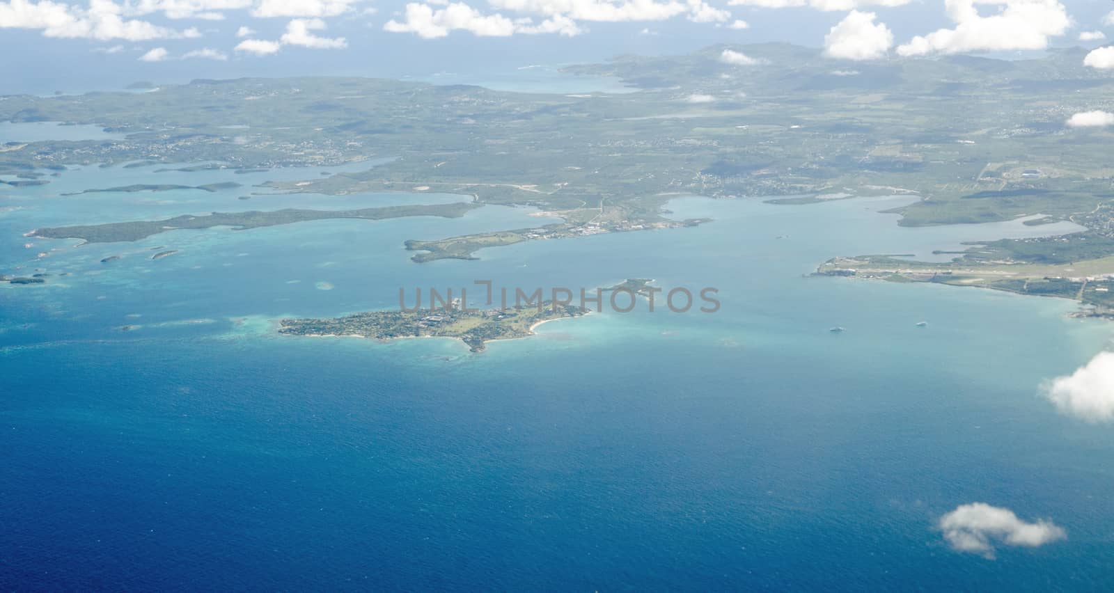 Aerial view of Antigua with the landmark Long Island, Fitches Creek Bay and Parnham Harbour with the promentary of Crabbs further away.  Sunny January afternoon.