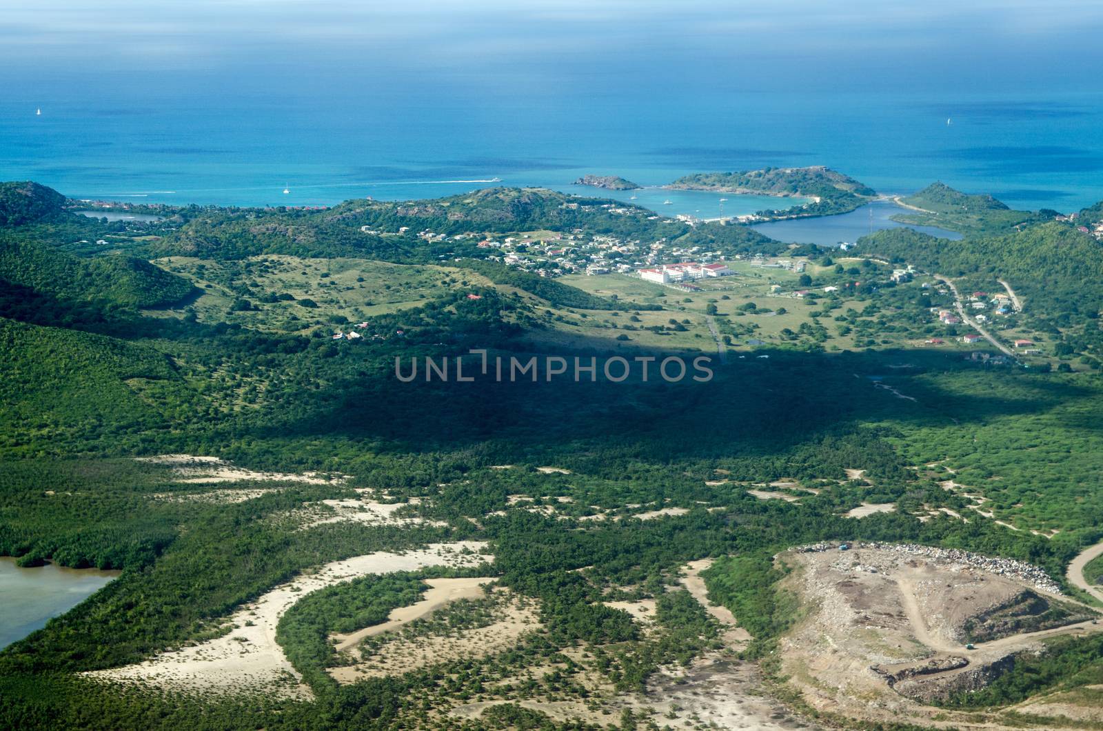 Aerial view of the Caribbean island of Antigua with the white buildings of the Antigua State College, Deep Bay Beach, Fort Barrington National Park and Galley Bay.