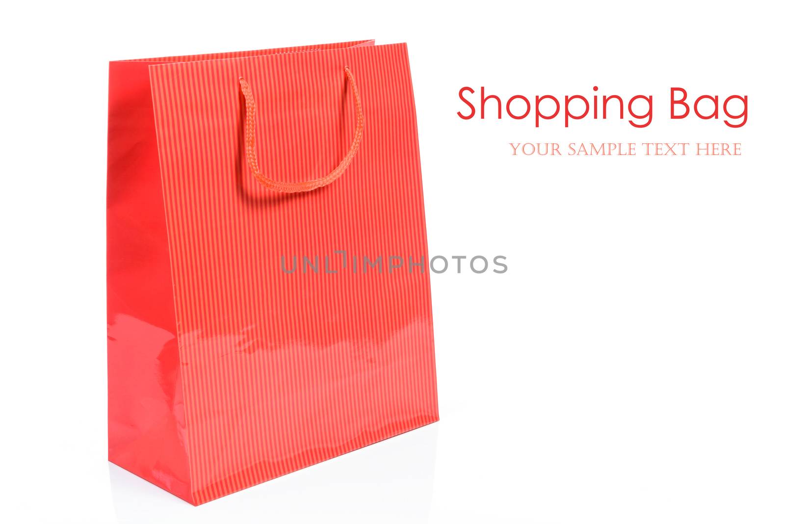 Luxury red shopping bag in close-up and isolated on a white background with copy space place (sample text).