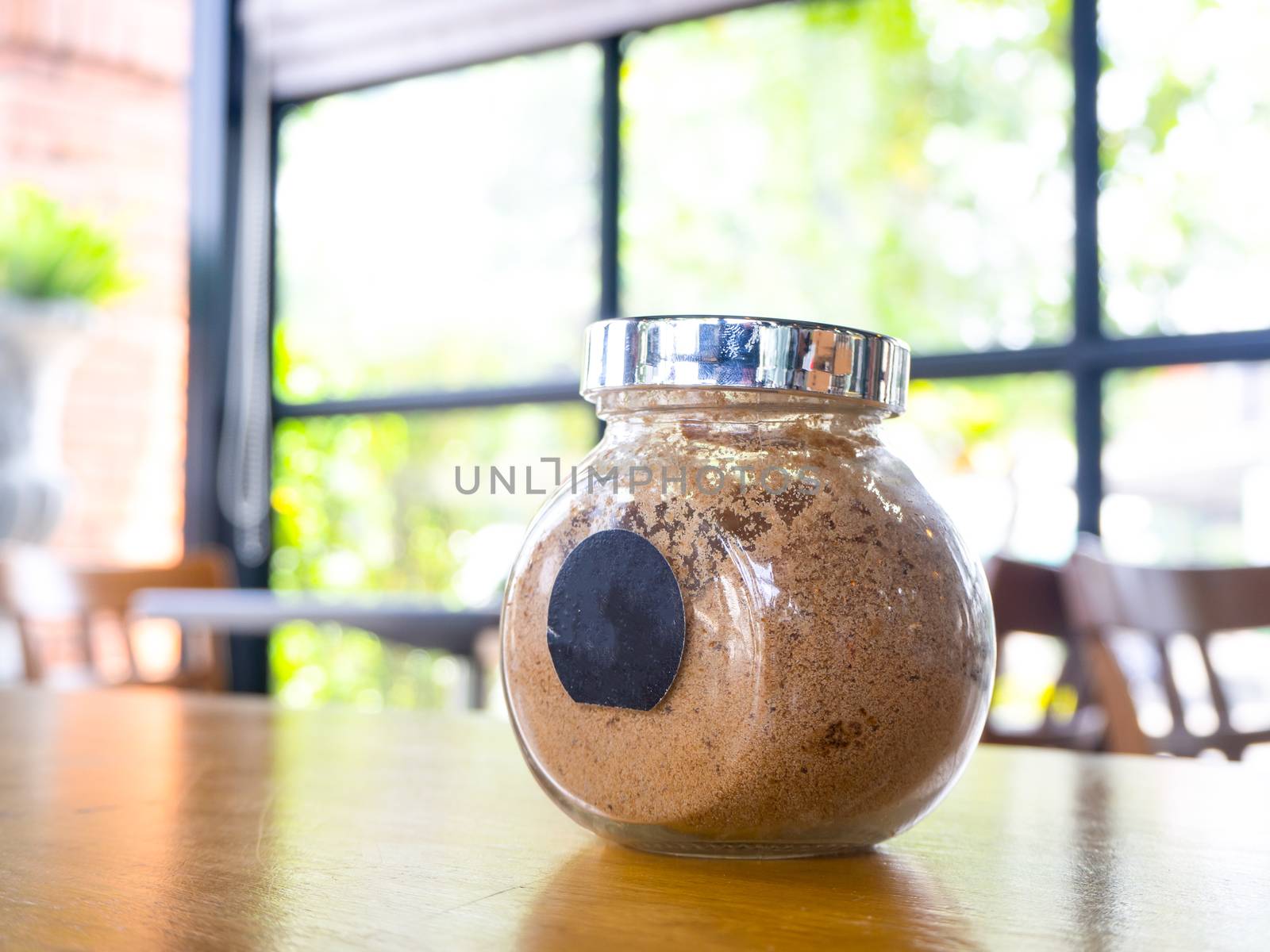 sugar in  glass jar on wood table for coffee.