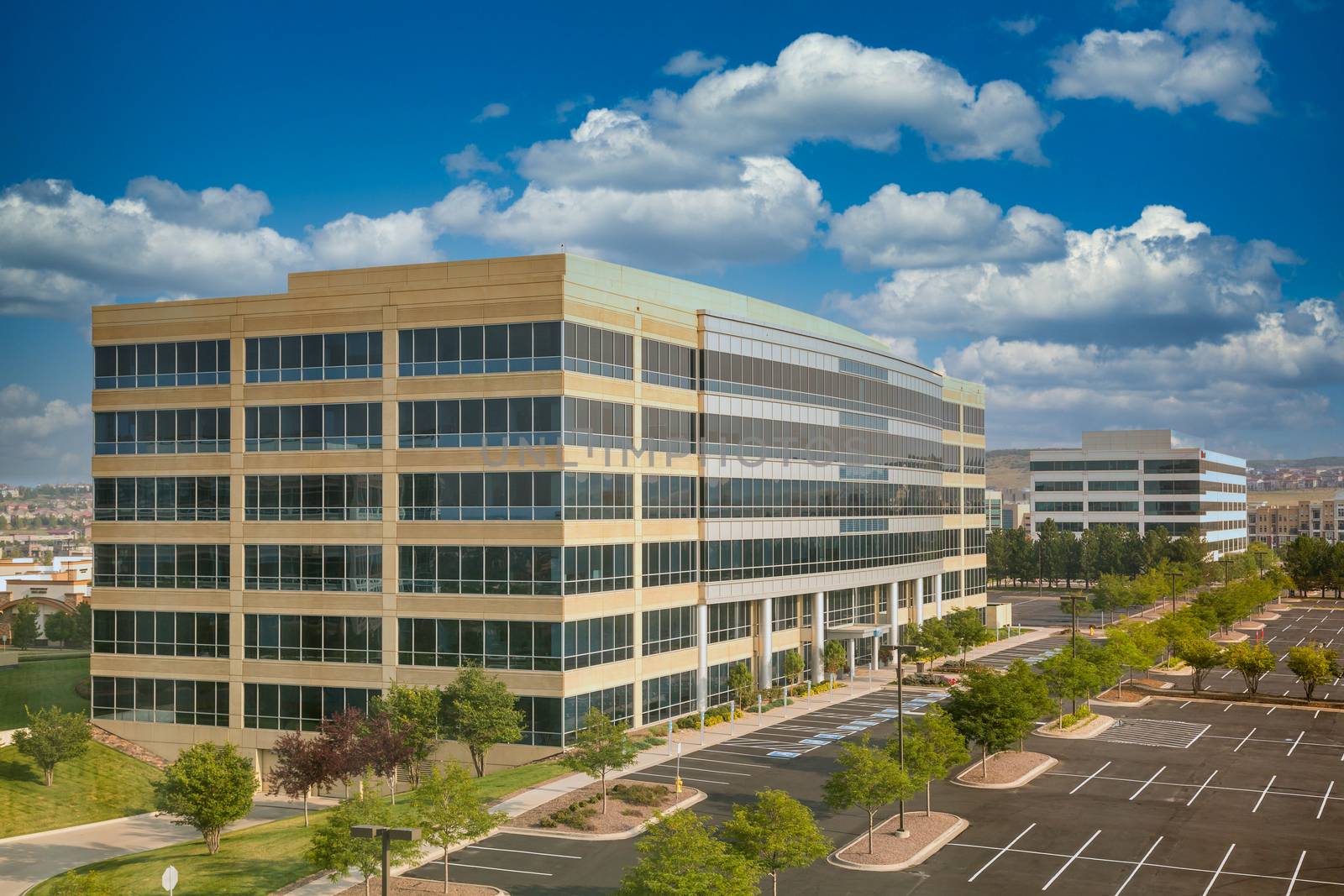 A modern white concrete and blue glass office building