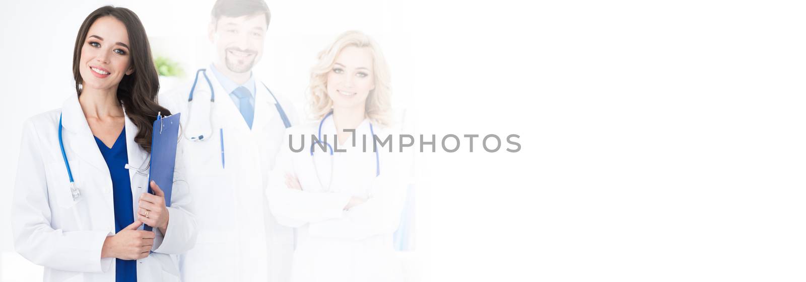 A medical team of doctors, men and woman, isolated on white background with copy space