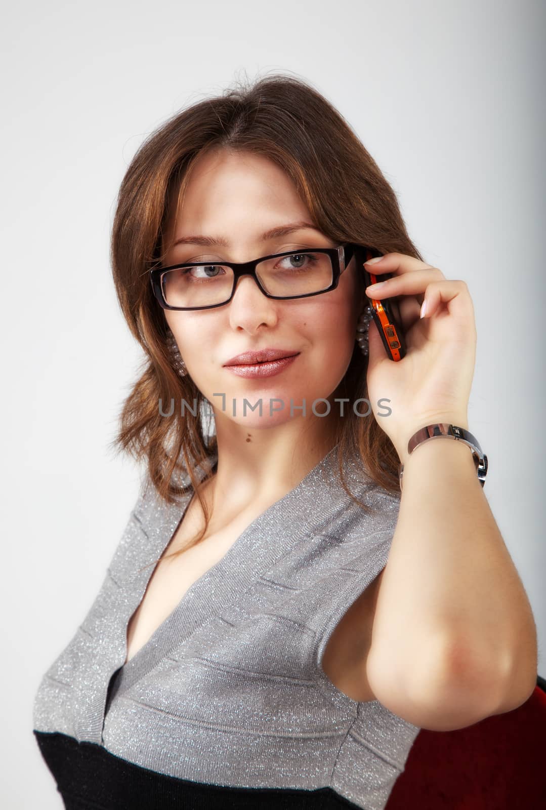 portrait of pretty girl with mobile phone in the office