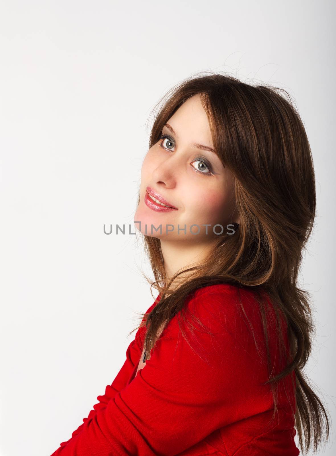 portrait of pretty young girl in red dress in studio