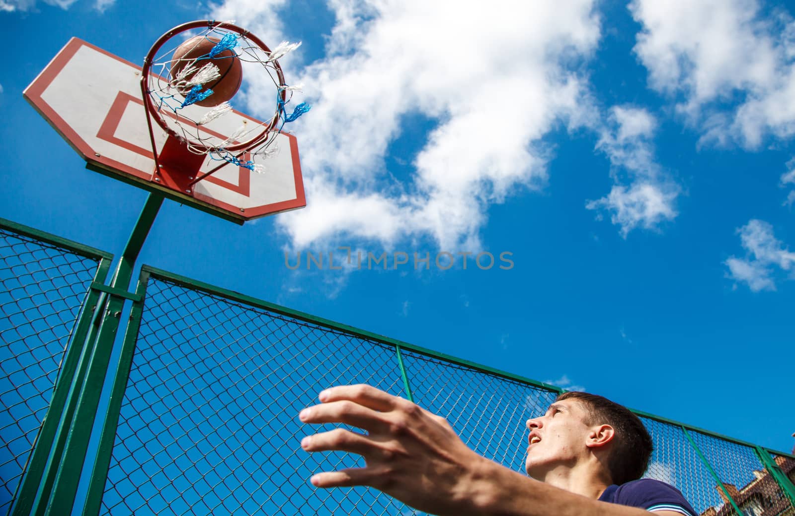 young man playing basketball by raddnatt